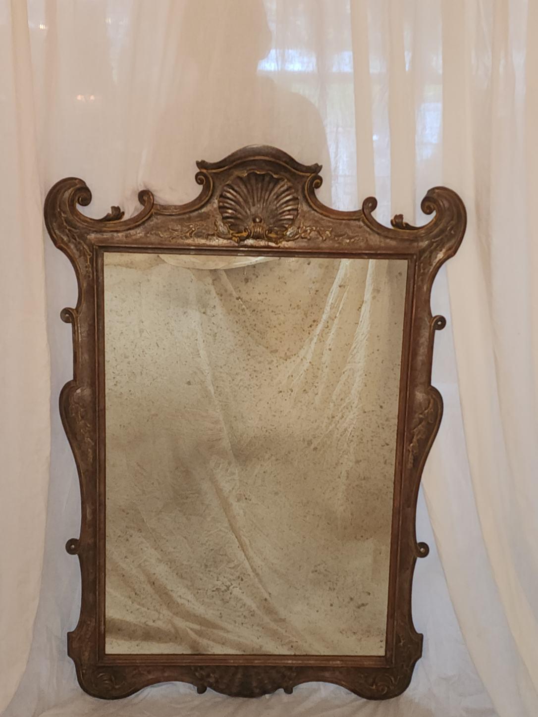 This Antique mirror is one of a kind. Made in the Baroque style, hand carved by creator Giovanni Chelini.
No work has been done on this piece, All original parts in tact.
A Vintage piece such as this one belongs in a main hallway and or study. 
A