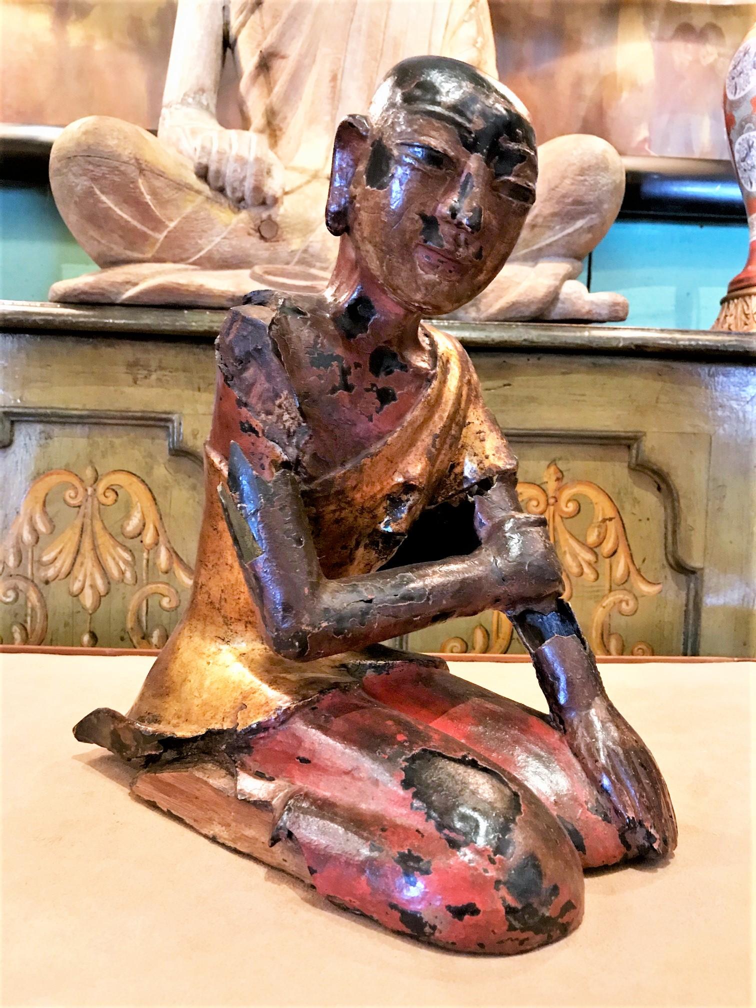 A beautiful 19th century Buddhist temple monk statue featuring a carved giltwood finish and depicted in a kneeling position Featuring delicate hands and life like face Buddha Monk statue probably created by Buddha Monks . Antiques Los Angeles Dealer
