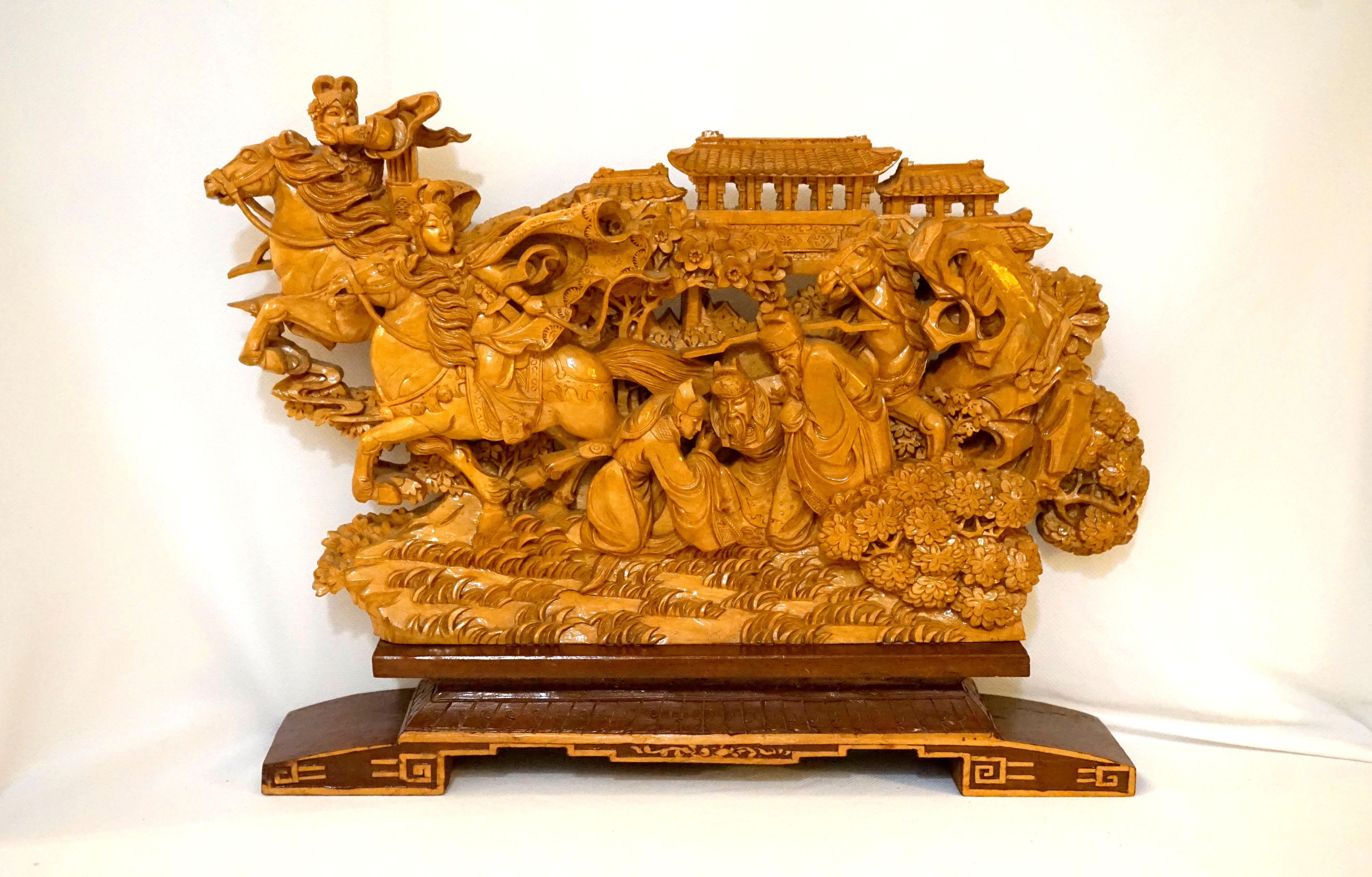 A Chinese carved softwood architectural fragment from the late 19th century.
is profusely carved with figures that include horses, birds and a pagoda that overlooks the events portrayed on the landscape, which is supported on a newer stand. The