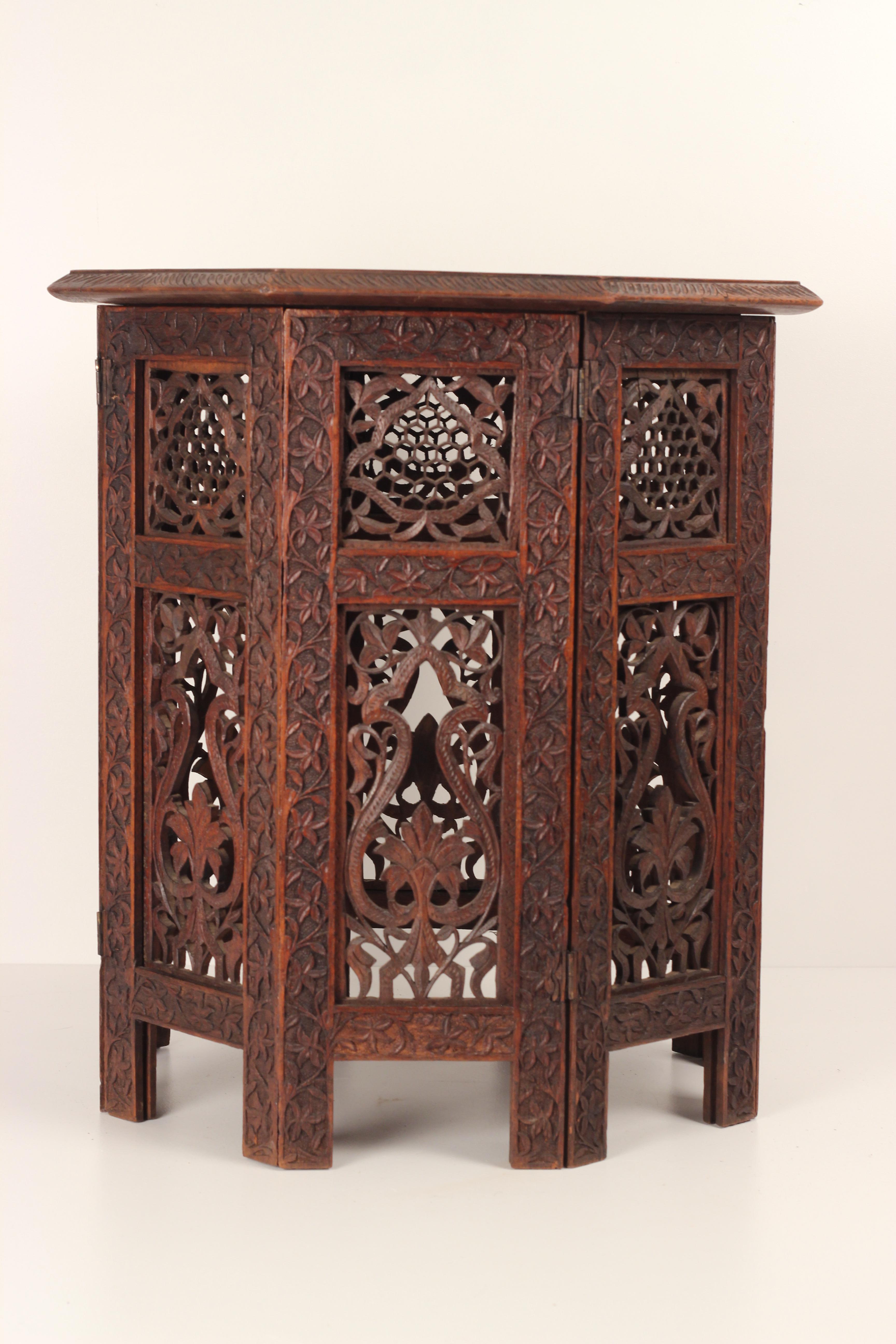 Antique Ottoman side table made around the end of the 19th century from Northern Africa. An ornately carved geometric design with delicate Bone flowers in the Style of the Ottomans. This Octagonale table serves as a functional and practical side