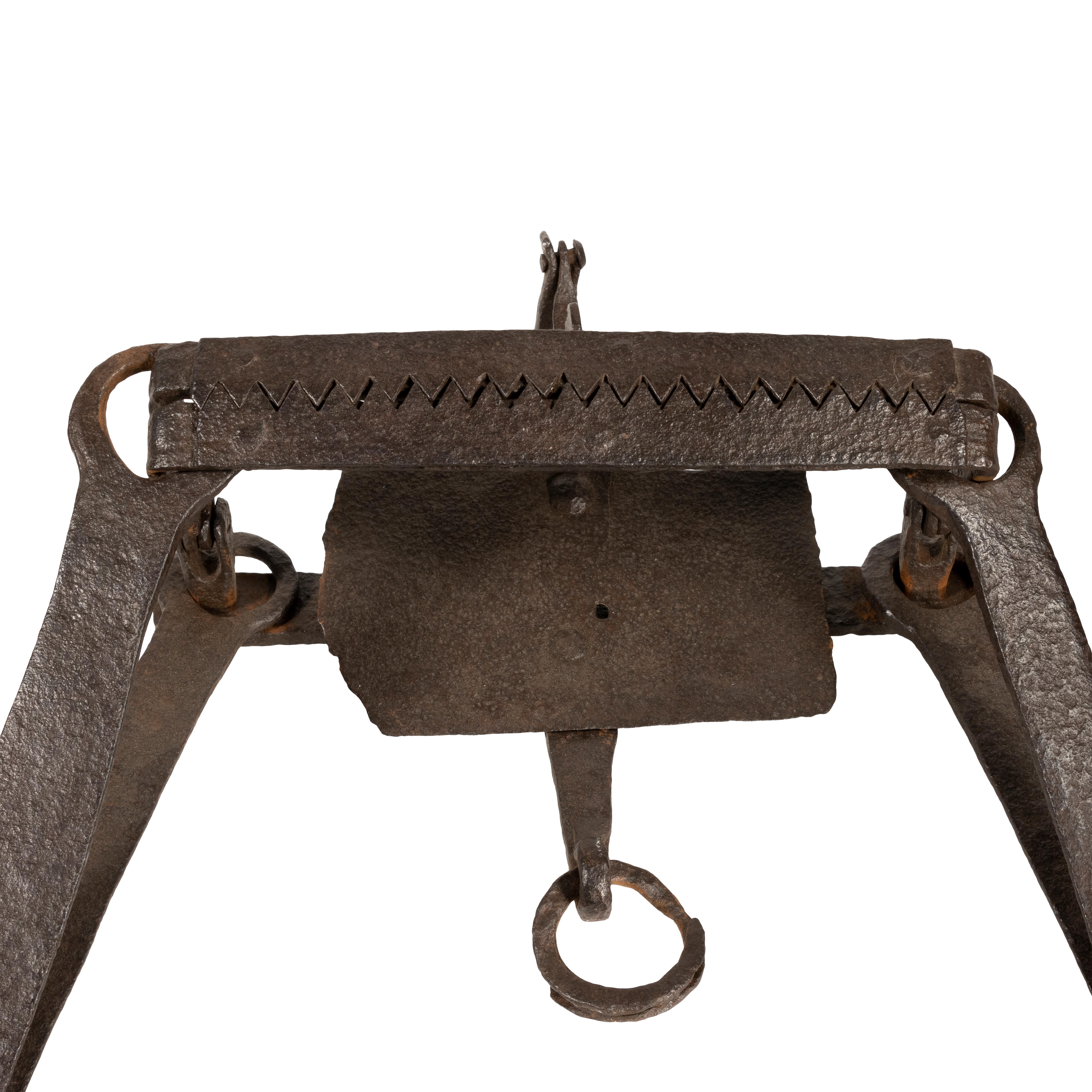 Hand forged bear trap with extra-large pan, serrated jaws attached by rivets. Unique chain attachment opposite the pan toggle. From the patina and wear this one appears to have been 