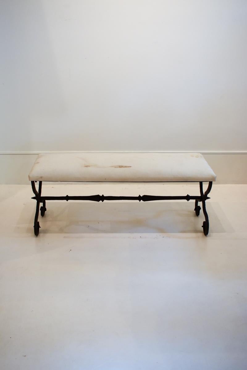 This 19th-century hand-forged iron bench is a beautiful example of the craftsmanship of the period, combining functional design with timeless elegance.The bench showcases the craftsmanship of the 19th century with its sturdy, hand-forged iron frame.