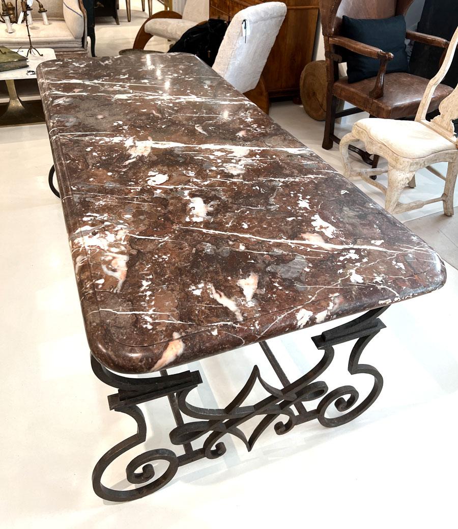 Cette superbe table de salle à manger en fer forgé à la main du XIXe siècle est un chef-d'œuvre d'artisanat et d'élégance. La table est dotée d'une base en fer au design complexe, mettant en valeur l'habileté et l'art des forgerons qui l'ont créée.