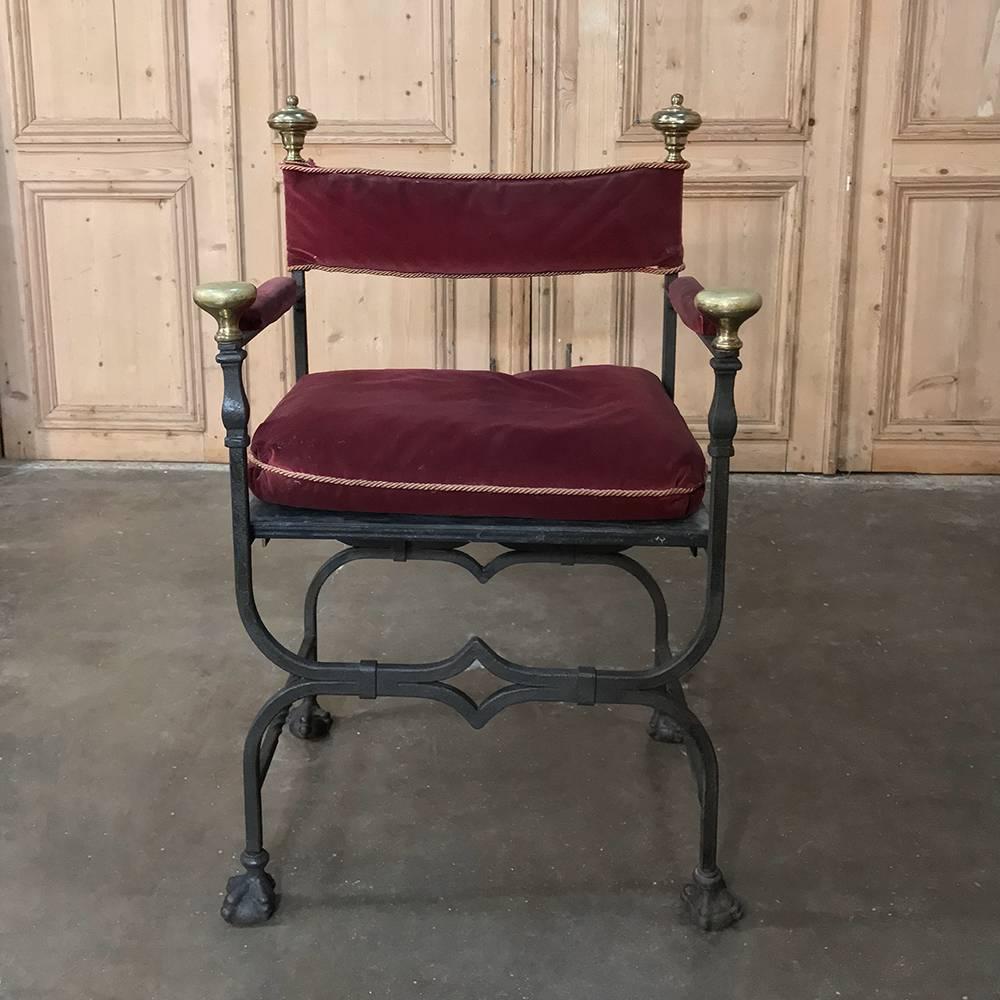 19th century wrought iron and brass Faldistorio armchair was handcrafted during the waning years of the 19th century, and features exquisite lines accentuated by bronze caps atop the four uprights, with velvet stretched between to form the seatback,