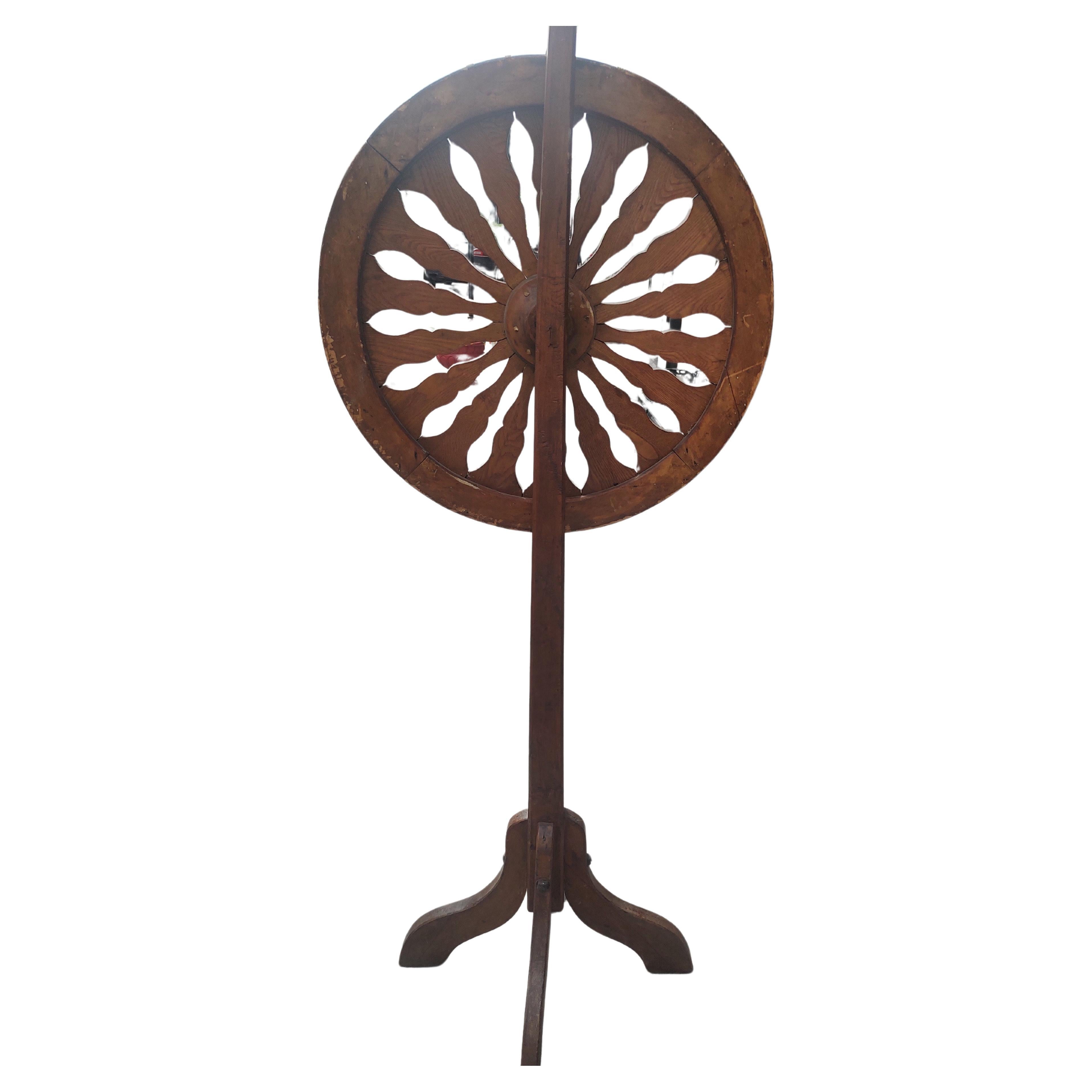 Fun and fabulous Folk Art Carnival Spinning Wheel from the latter part of the 19th century. Totally original and in fantastic condition. Nice old Ted and black paint looks to be correct. Leather ticker and all the nails in place. Disassembles for