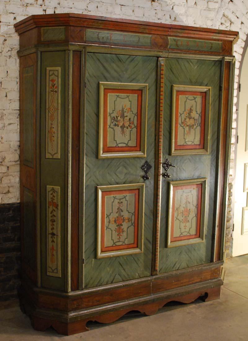 A unique hand painted rustic cupboard coming from Austria and dated to 1813.
This farmhouse wedding cabinet is in a good condition and shows beautiful patina.
The two big doors on the front display hand painted flowers and garlands.
The base