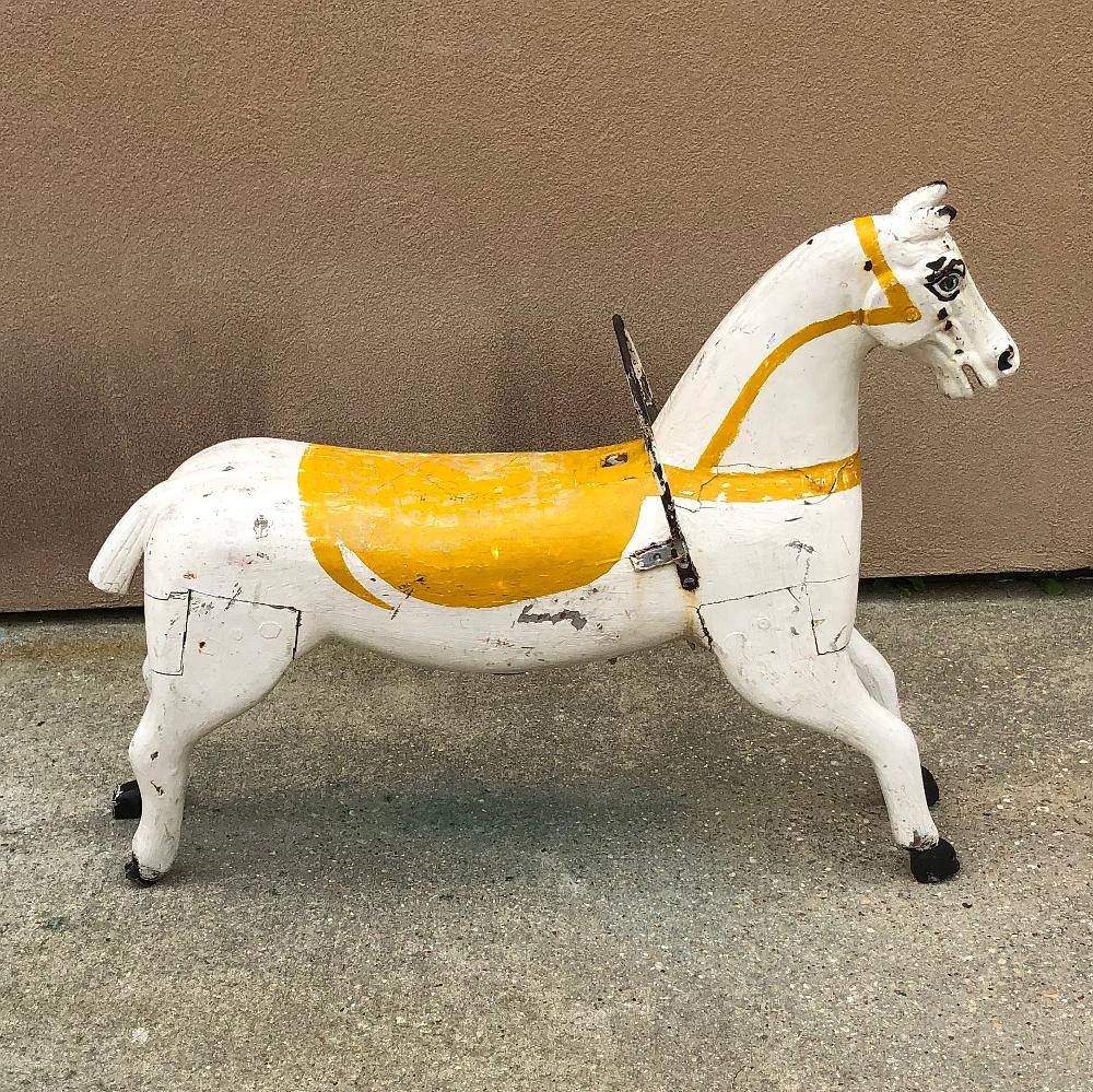 19th century hand painted carved wood Carousel Horse is a splendid artifact of nostalgia, back when huge, brightly lit carousels were the centerpiece of traveling amusement parks, fairs and circuses during their heyday in the 19th century. This
