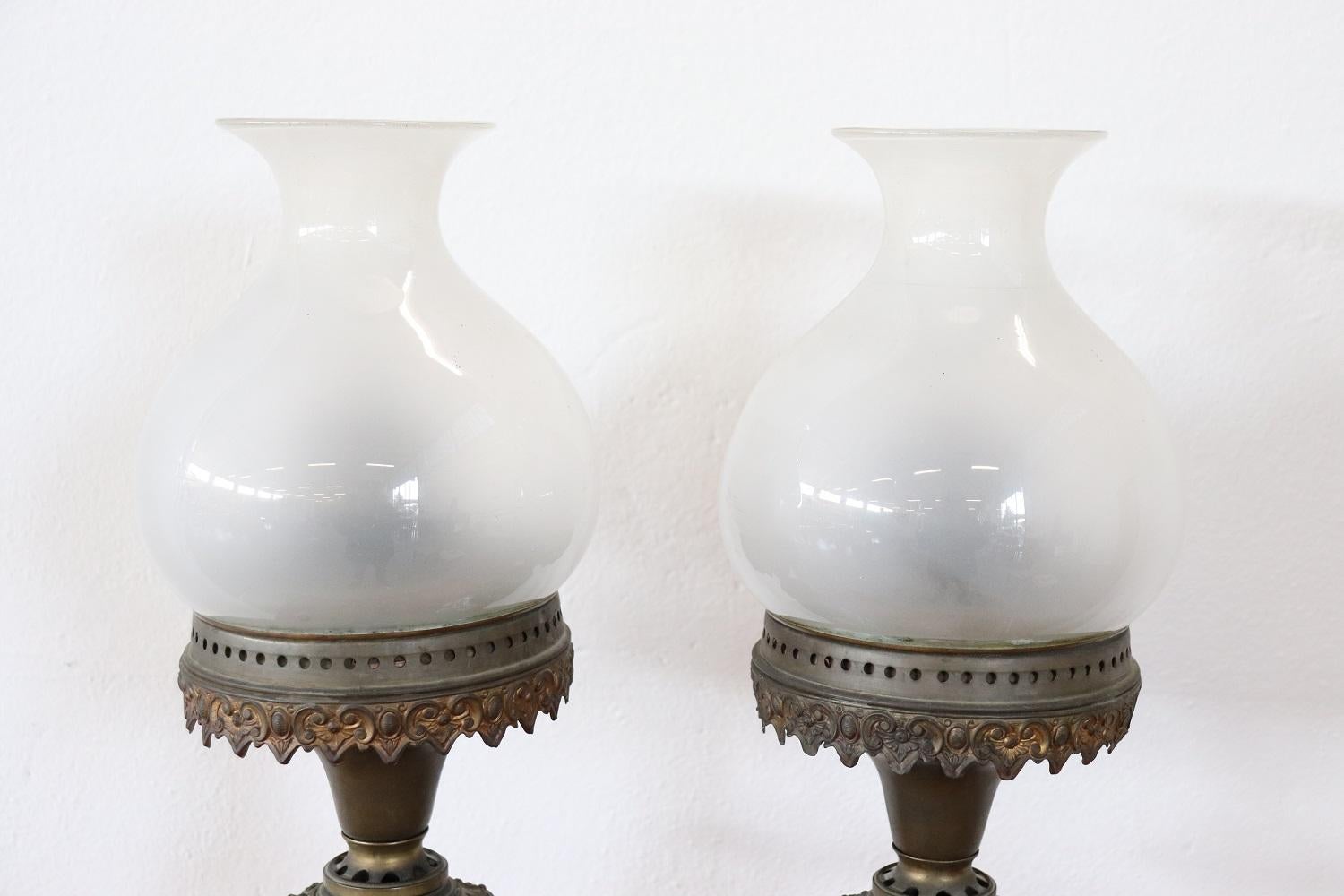 Beautiful antique table lamps in ceramic and finely chiselled bronze base. The ceramic is hand painted with floral and chinoiserie decorations. These lamps are ancient and originally worked with oil.