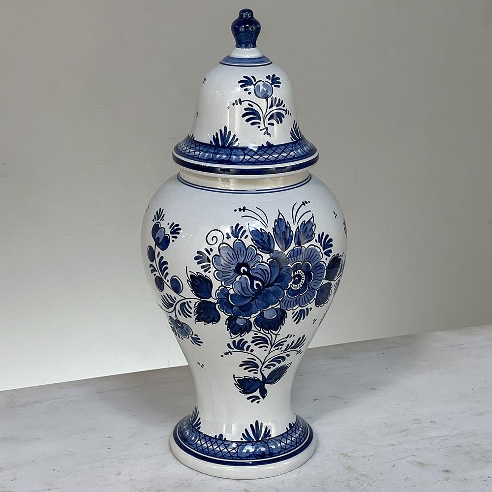 19th Century Hand-Painted Delft Blue & White Lidded Urn represents a departure from the Oriental styling and the introduction of a more European look that was part of the evolution of porcelains from the Delft region of Holland over the past three