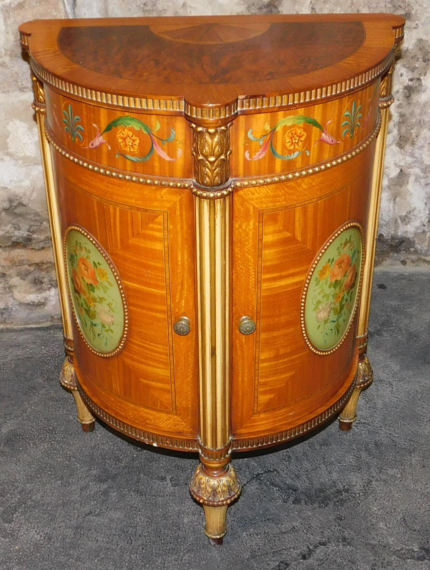 A beautiful circa 1890 mahogany, maple, burled walnut, satinwood inlaid English Sheraton Revival demilune side cabinet with neoclassical paintings. Hand painted with various veneers and double doors.