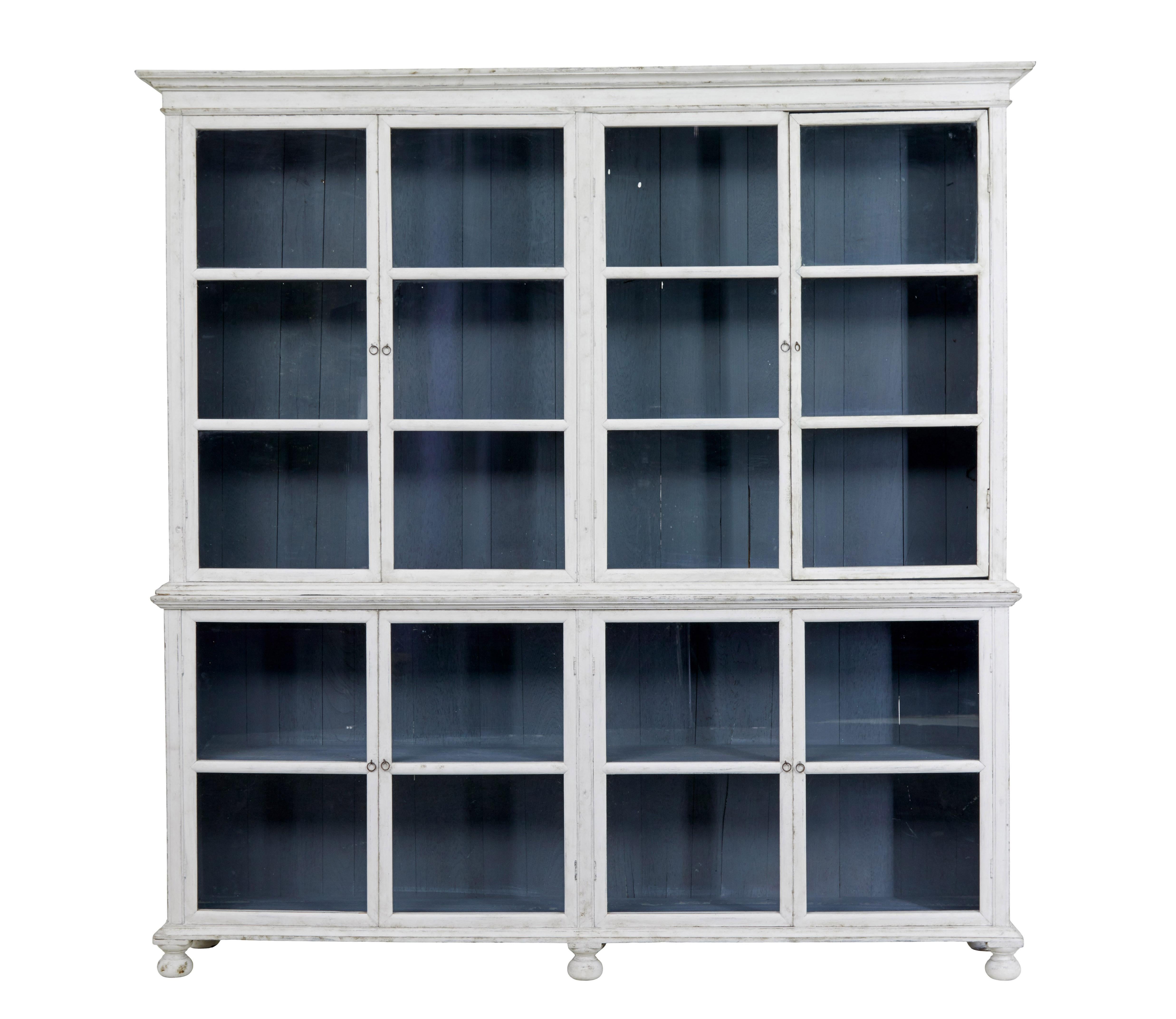 Rustic 19th century painted glazed vitrine circa 1890.

Good quality cabinet that would work well around the home or for retail display.

Comprising of 2 sections, each fitted with 2 double doors and glazed panels.  Top section with cornice with