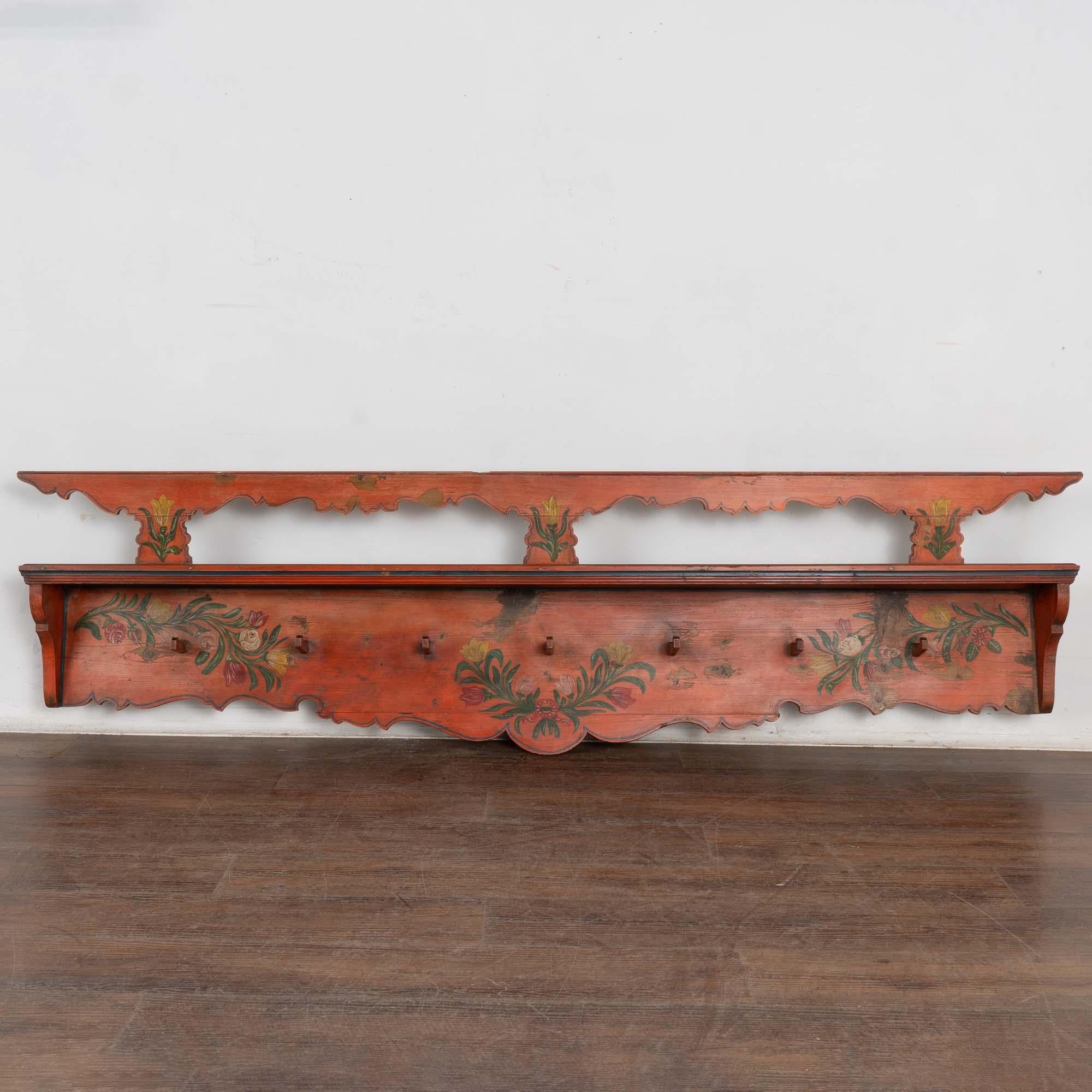 This fun and festive hanging rack is a wonderful example of the folk art found in Eastern Europe during the 1800's.
The original salmon colored background has hand painted accents including yellow and red flowers against green leaves and