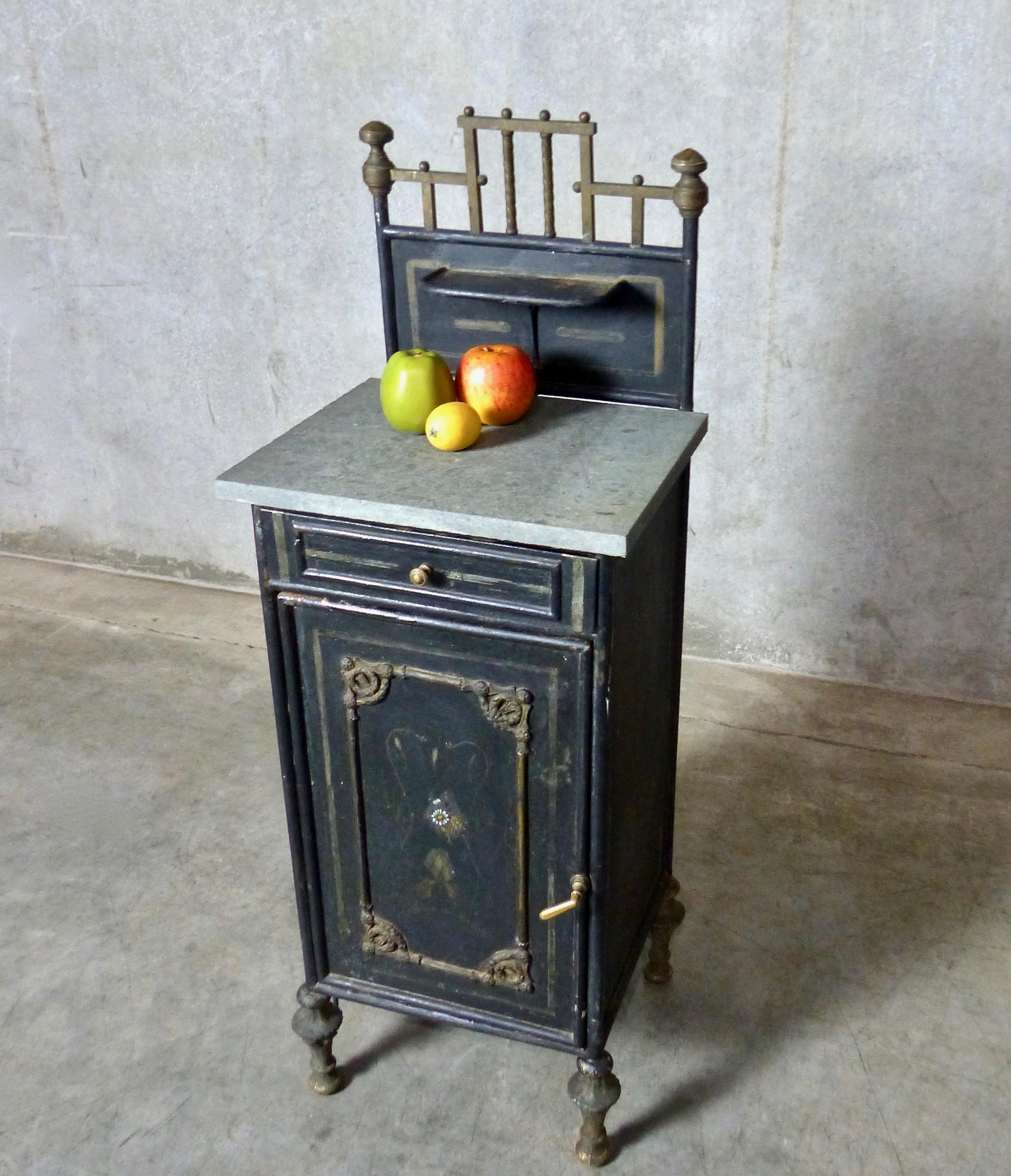 A charming washstand/cabinet from circa 1890 France in original finish. Hand-painted front panel; brass accents and trim; speckled limestone top. Single drawer plus interior shelves. Finished on all sides, which makes this compact cabinet easy to