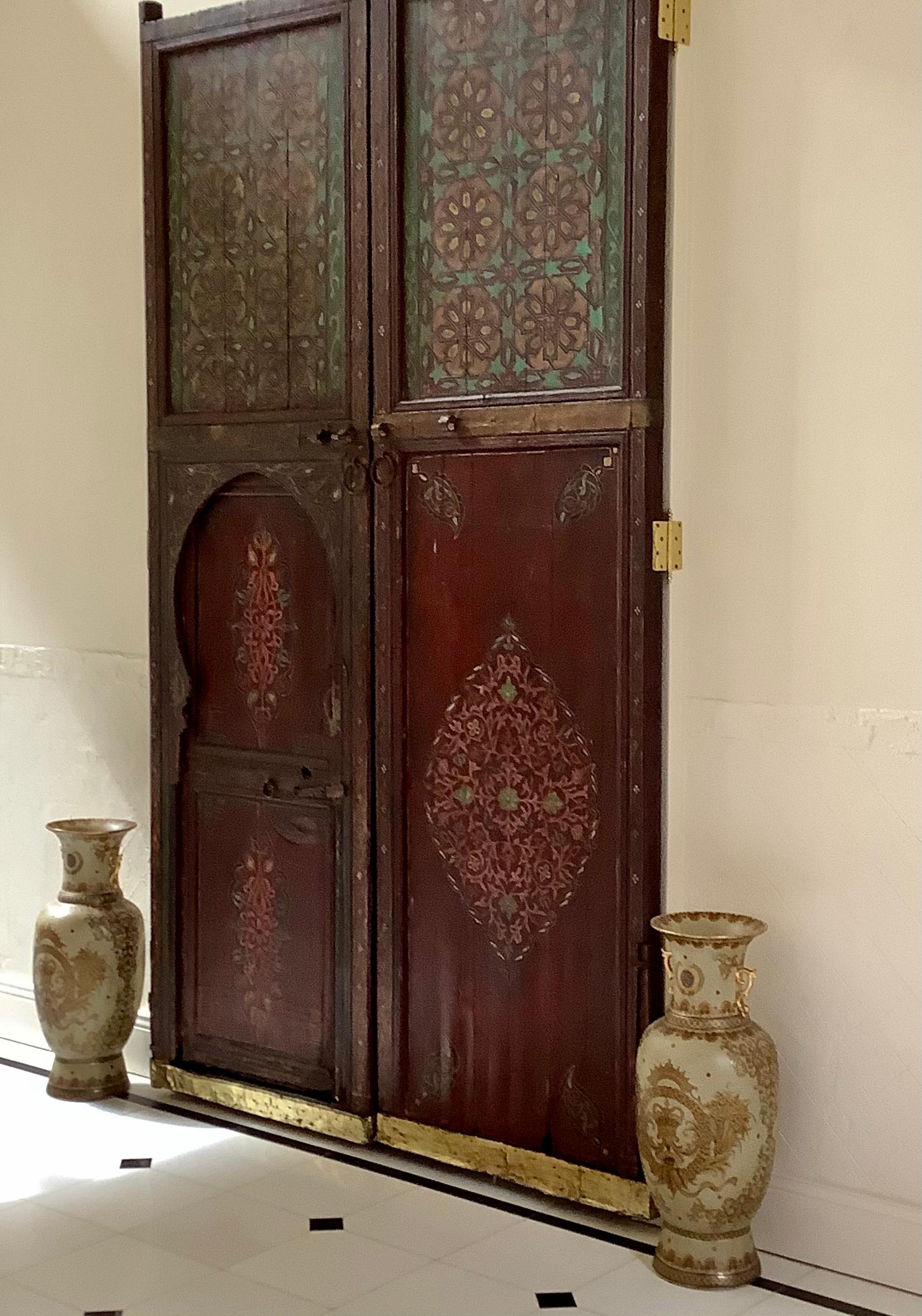 19th Century Hand Painted Moorish Moroccan Antique Double Doors

Extra large in size, scaling 12'+ in height, these double doors are antiques from the 19thC boasting with color and artwork. Each panel is decorated and painted by handmade wood carved