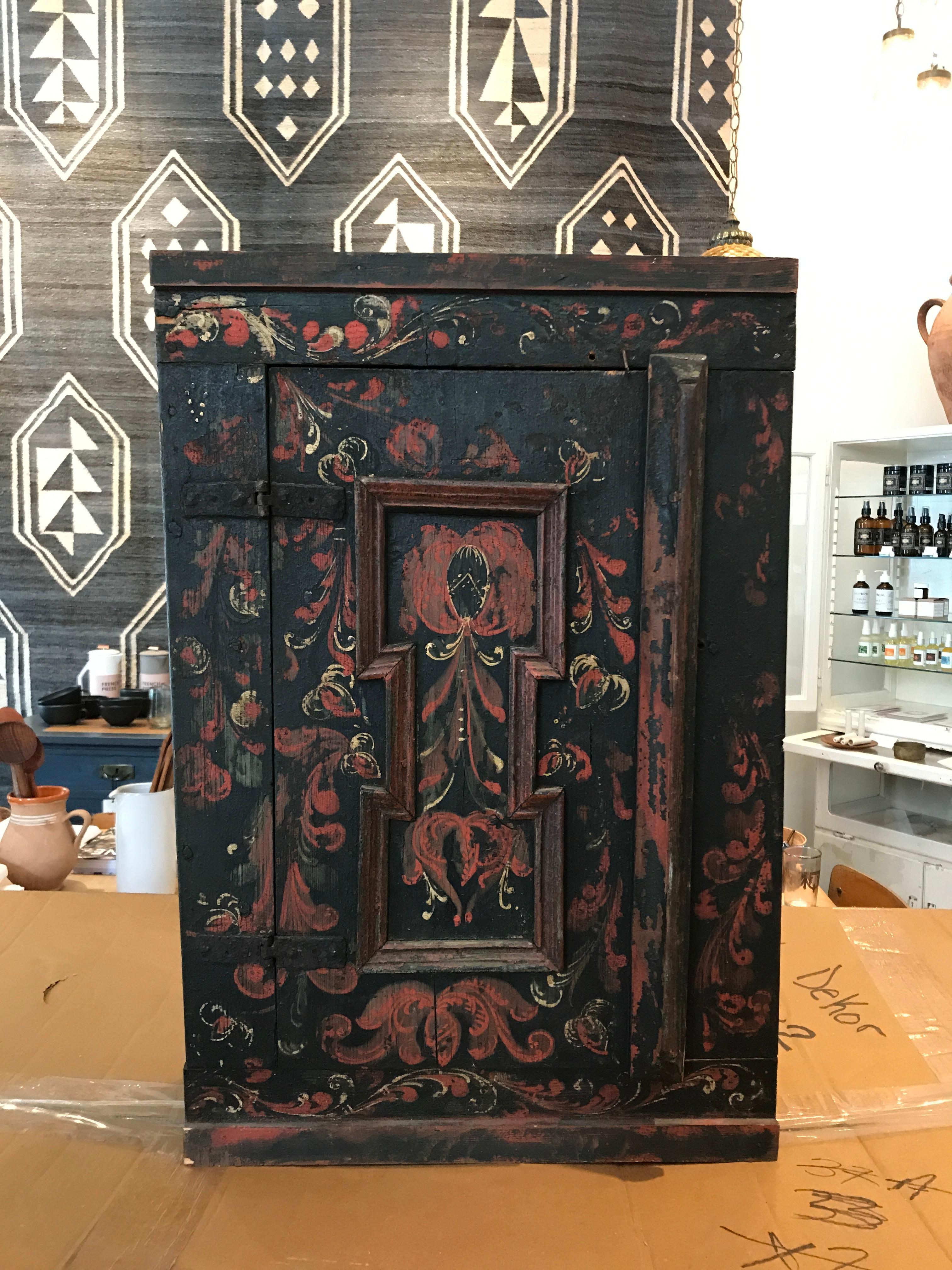 An absolute piece of art! This 19th century priest wall cabinet, both hand painted and handcrafted, has stand the test of time. Paint and wood grain aged so elegantly and shows wear of consistent use from a practicing priest.

Cabinet closes by a