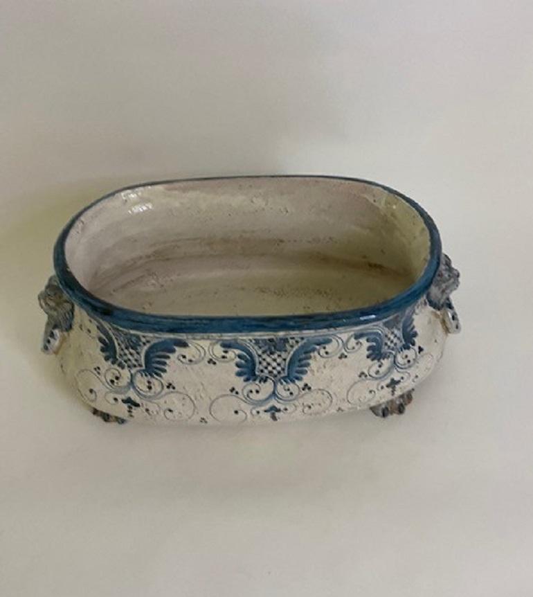 Old Blue & White Hand Painted Oval Porcelain Faience Footbath with Ornate Faux Carved Lion Head Handles and Resting on Carved 
