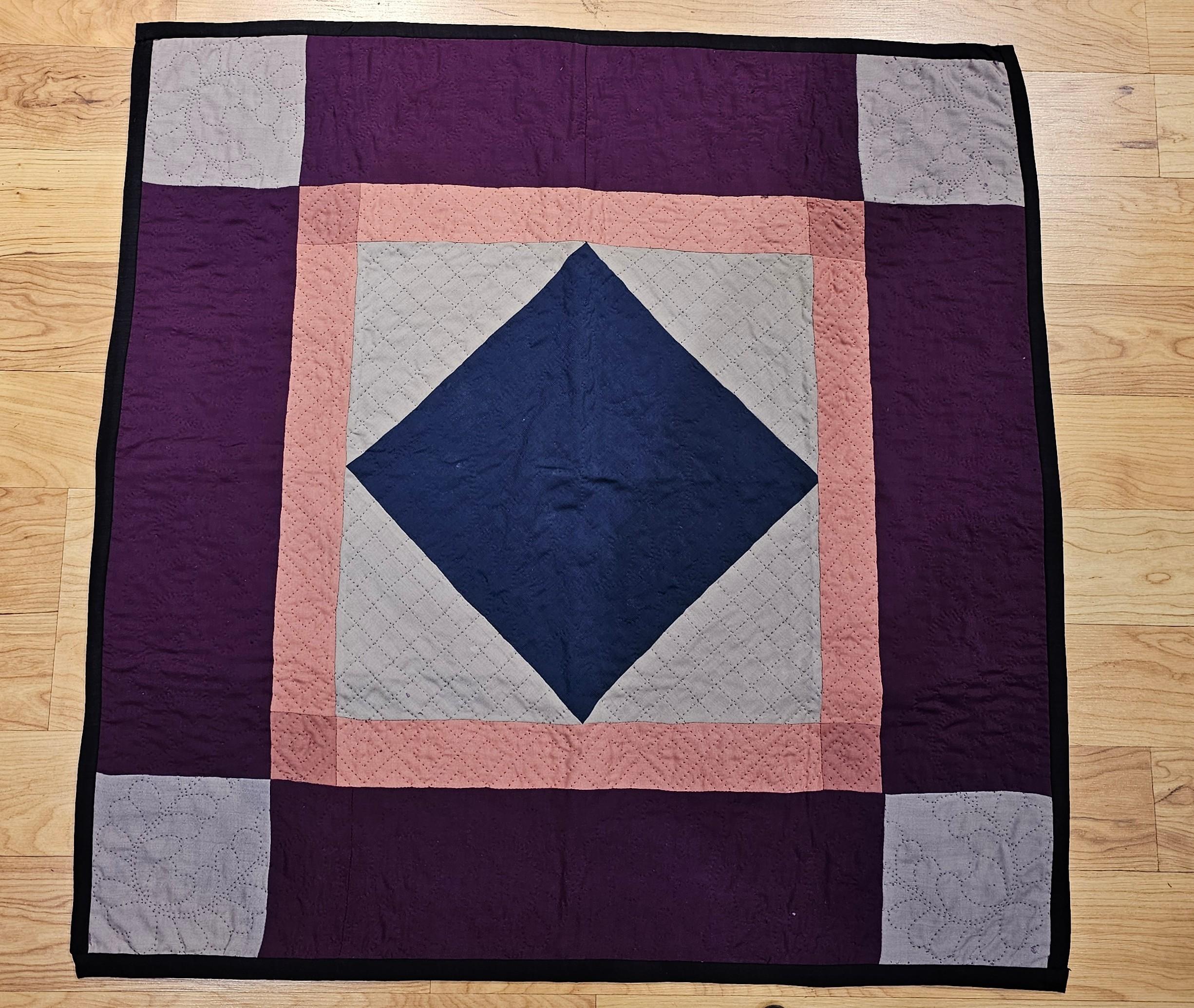  19th century hand-stitched and quilted American Amish Crib Quilt in a” Diamond in a Square” pattern from Lancaster County, Pennsylvania.   The quilt has a very fine hand stitching with primary colors of ivory, pink, burgundy, and navy blue.  The
