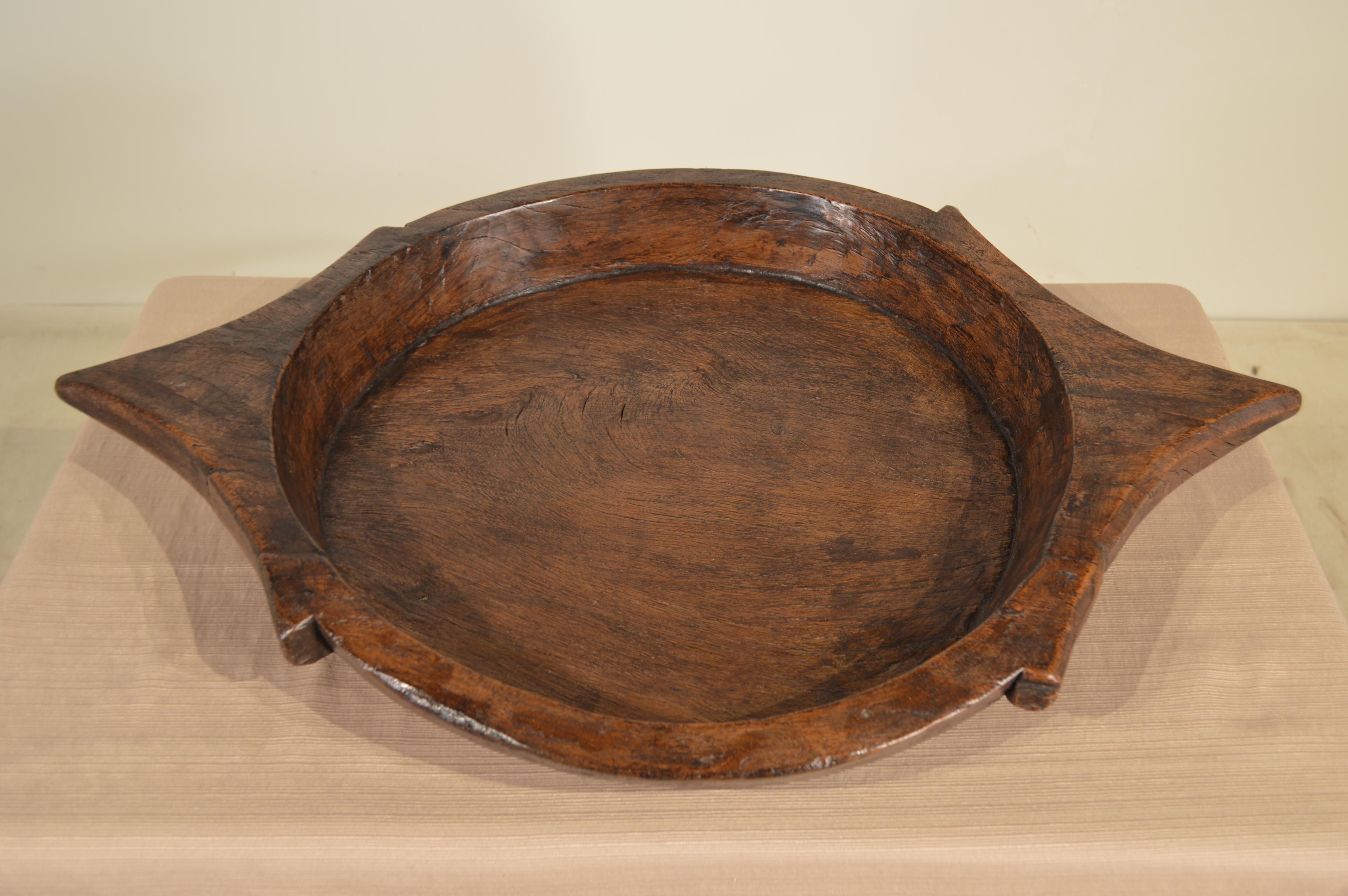 19th Century hand-hewn wooden bowl made from fruitwood with primitive style handles.