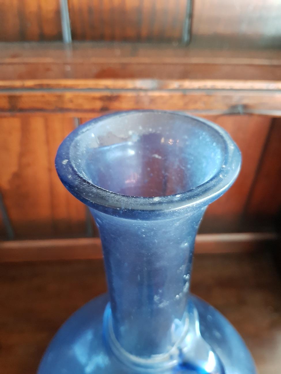 19th century handblown blue jug with a beautiful fitted ear which revolves around the neck, slight traces of use but no cracks or chips.

The measurements are:
Depth 21 cm/ 8.2 inch.
Width 21 cm/ 8.2 inch.
Height 35 cm/ 13.7 inch.