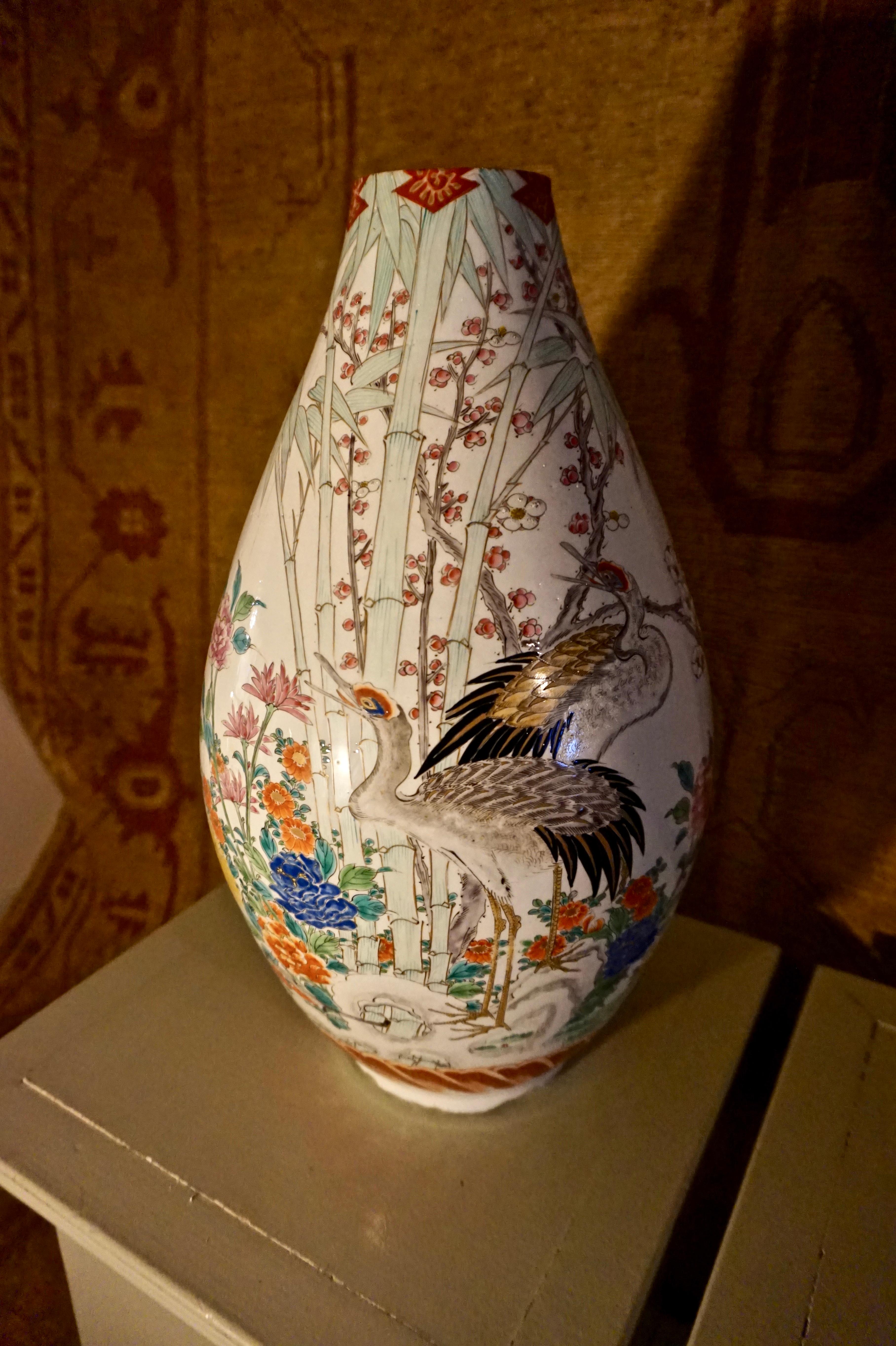 Large Japanese Conical vase in the style of Famille Verte with exquisitely painted cranes and flying song birds amidst spring foliage. Some hairline cracks are visible but these do not detract from the Fine Art work on display in the scenes