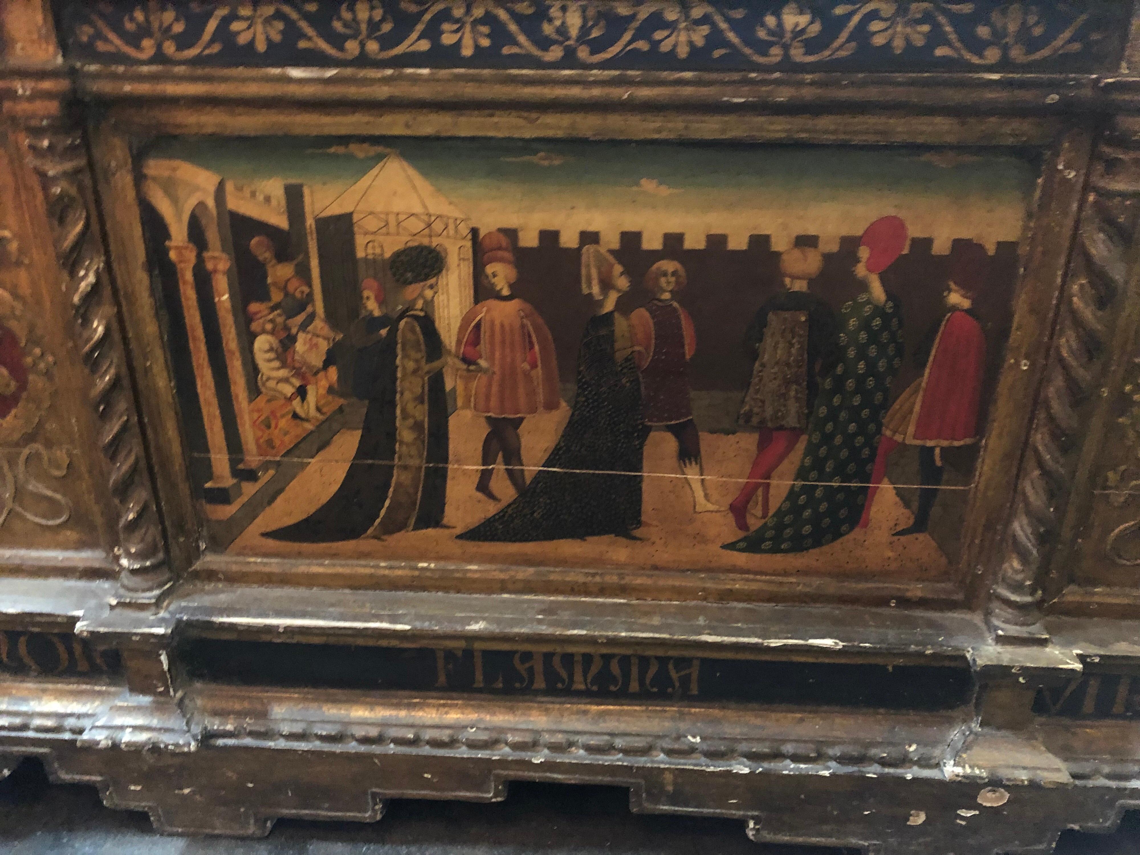 Outstanding hand painted and carved Italian Cassone from Italy. Depicts a scene of fine ladies and gentlemen in a courtyard. Decorative designs on each side of the portrait. The top have very nice gold gilt and a beautiful crest in the middle. It