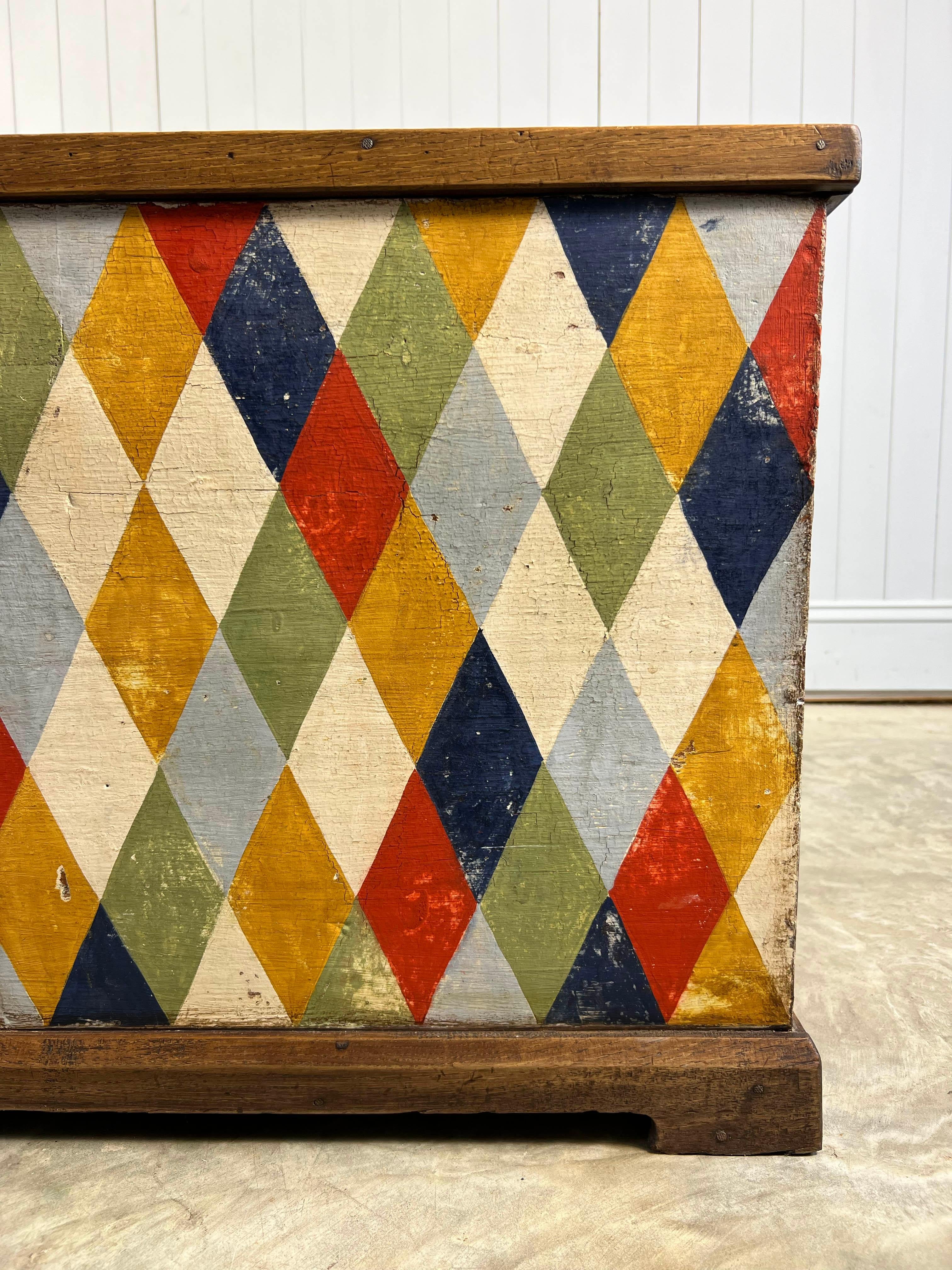 This 19th Century Italian Chest has been newly hand-painted by our friend Elisa who is based just outside Florence.  She is a specialist in creating really authentic decorative paint details and finish. She has added this striking harlequin