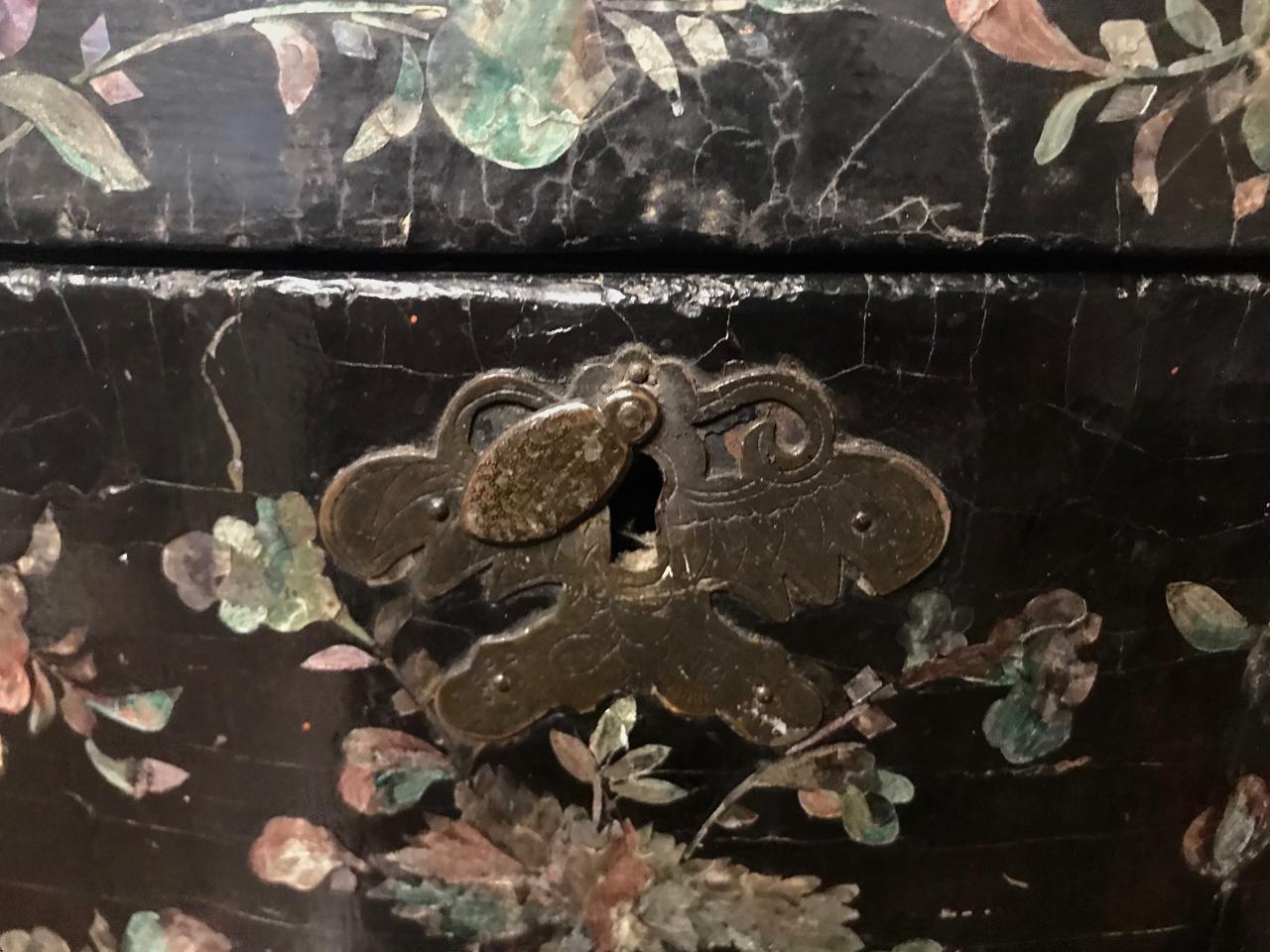 This is a unusual example of a 19th century hat box in Fine Chinese coromandel lacquer. The hat box retains its original butterfly shaped chased brass lock plate. The lacquer features inlaid floral designs to the body and an inlaid landscape with