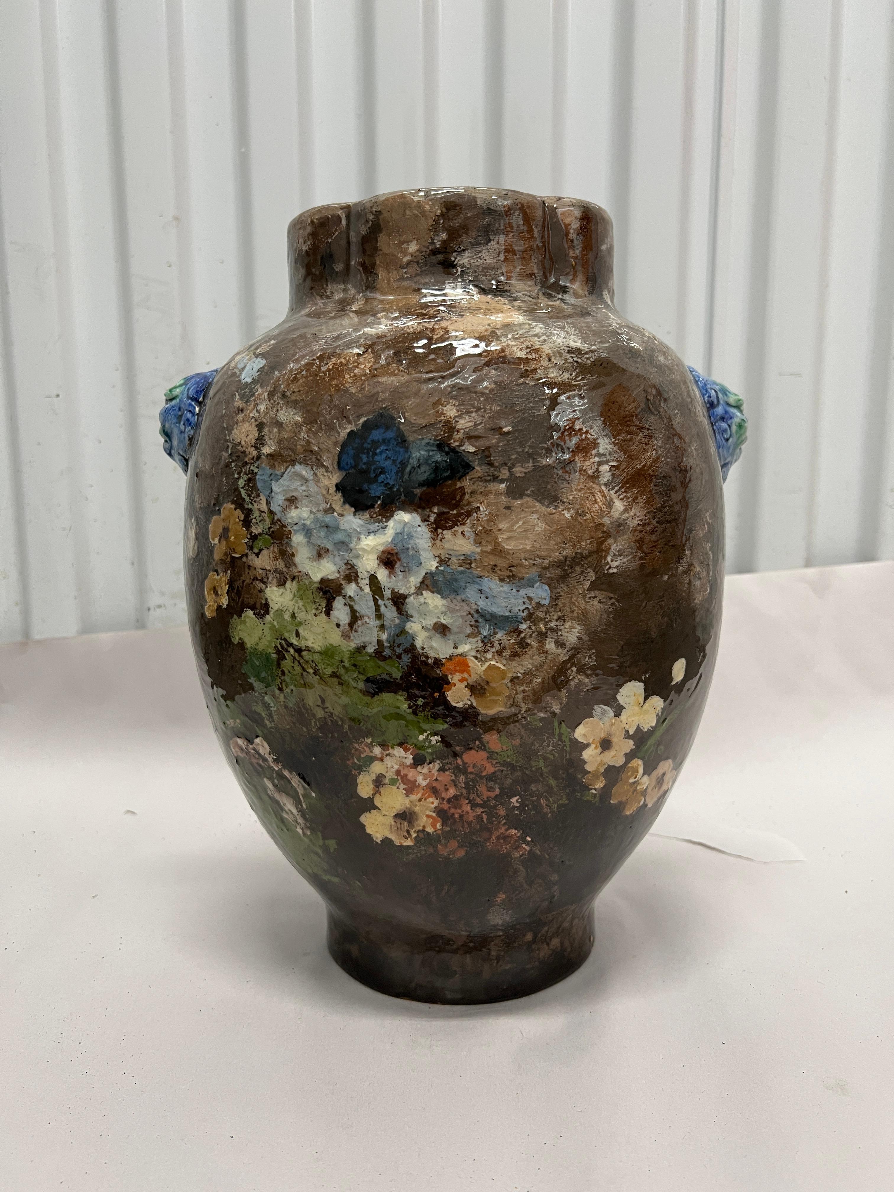 A beautiful Haviland & Co. terracotta barbotine vase with painted flowers, butterfly and lion handles.  Barbotine wares are typically early European ceramics that use a thin clay paste to makes designs in low relief.  Made in Limoges, France c.