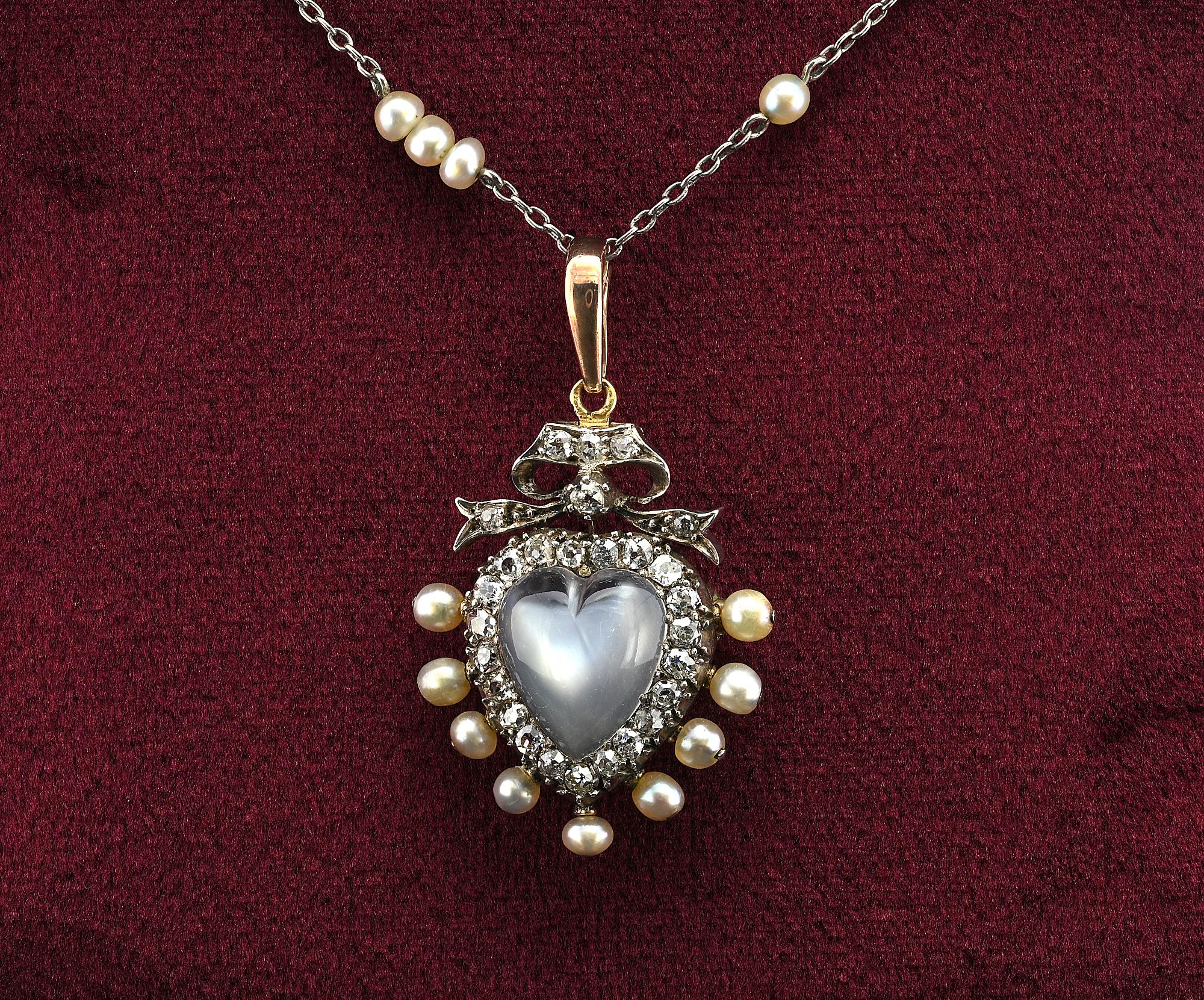 This superb 19th example of sentimental heart pendant is made of silver over 10 Carat gold electronically tested – it can b worn as a brooch too
The large luminous heart carved Moonstone is approx 3.00 Ct (11.1 x 10.8 mm) surrounded by 27 old mine