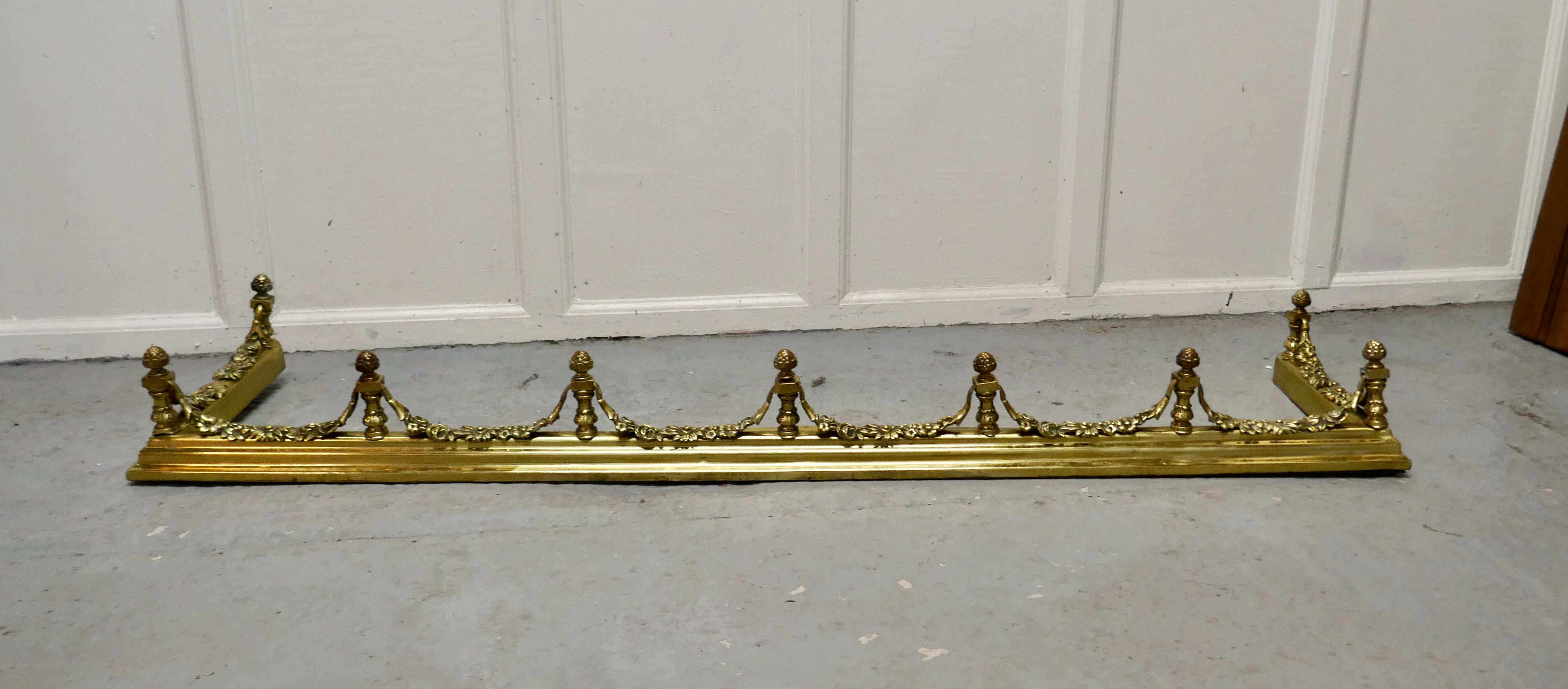 19th Century Heavy Brass Fender with Brass Garlands

This is a superb quality Brass Fender it has a broad base and elaborate spindles, with garlands of leafy swags this is one of the heaviest and finest quality fenders 
The Fender has delightfully