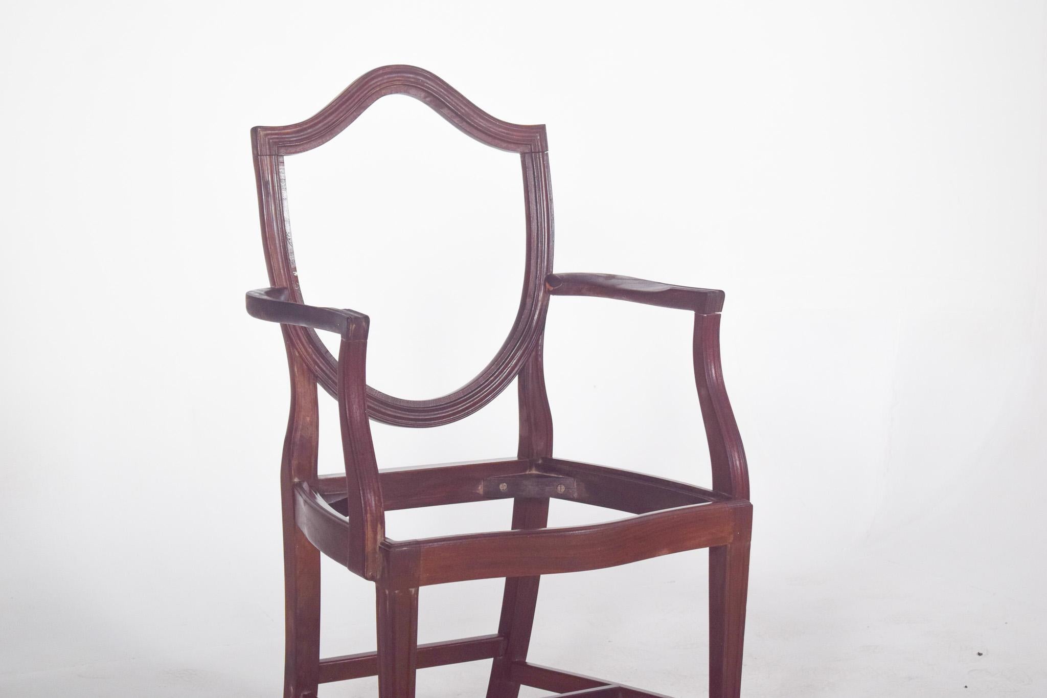 Sillón Hepplewhite. Estas sillas impresionan por su diseño elegante y delicado. Lo más destacado es el respaldo en forma de escudo con contornos suaves y curvados, típico del estilo Hepplewhite, muy común a finales del siglo XVIII y principios del
