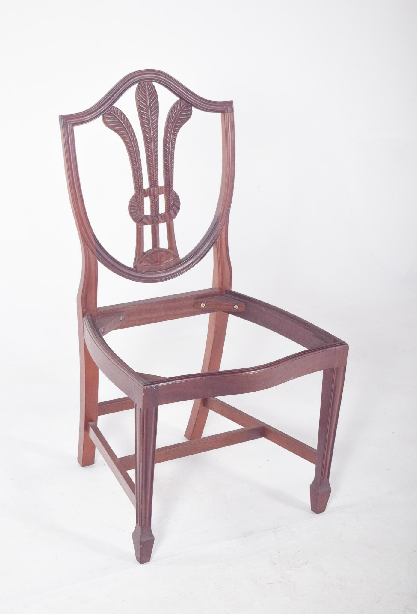 Hepplewhite style chair, without seat. This elegant, shield-shaped back chair, characteristic of the Hepplewhite style, with a warm-toned wood frame and polished finish, has a hollowed-out backrest, meticulous carvings in the form of stylised