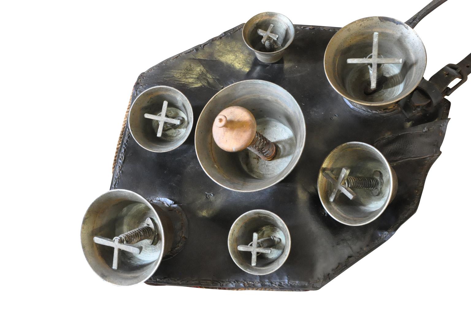 A delightful mid-19th century Herder's Cowbells. A fabulous collection of bronze bells attached to padded leather. The herder would wear this piece on his backs. Walking, the bells make the most beautiful tones. The cows would follow the herder from