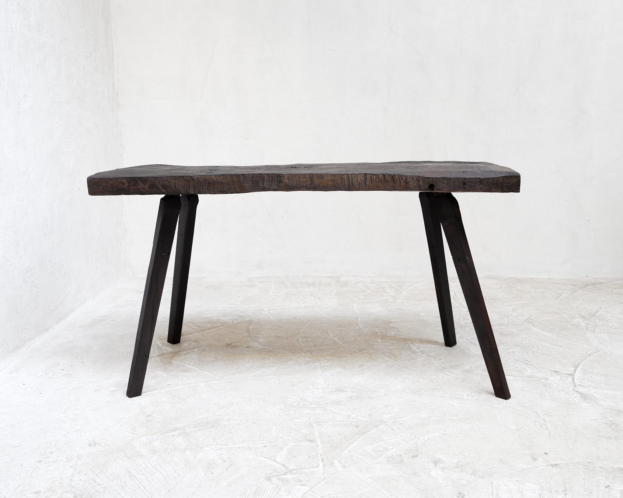 A 19th C. Solid beech table from the mountains of Transylvania.

Heavily patinated thick hand cut hewn top in matt wax finish.

-

We offer free shipping to the USA/Canada through Fedex with this item.