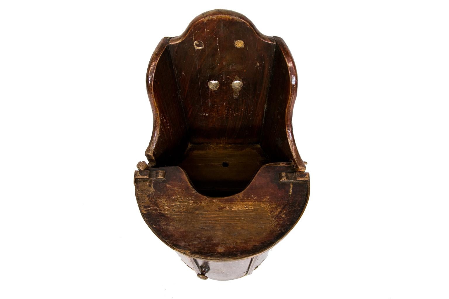 19th century high chair, this youth high chair cabinet can also be used as a potty. It is pine with the original red paint faux painted to simulate rich wood. It has a bow front with white designs in the door which is opened by the original turn