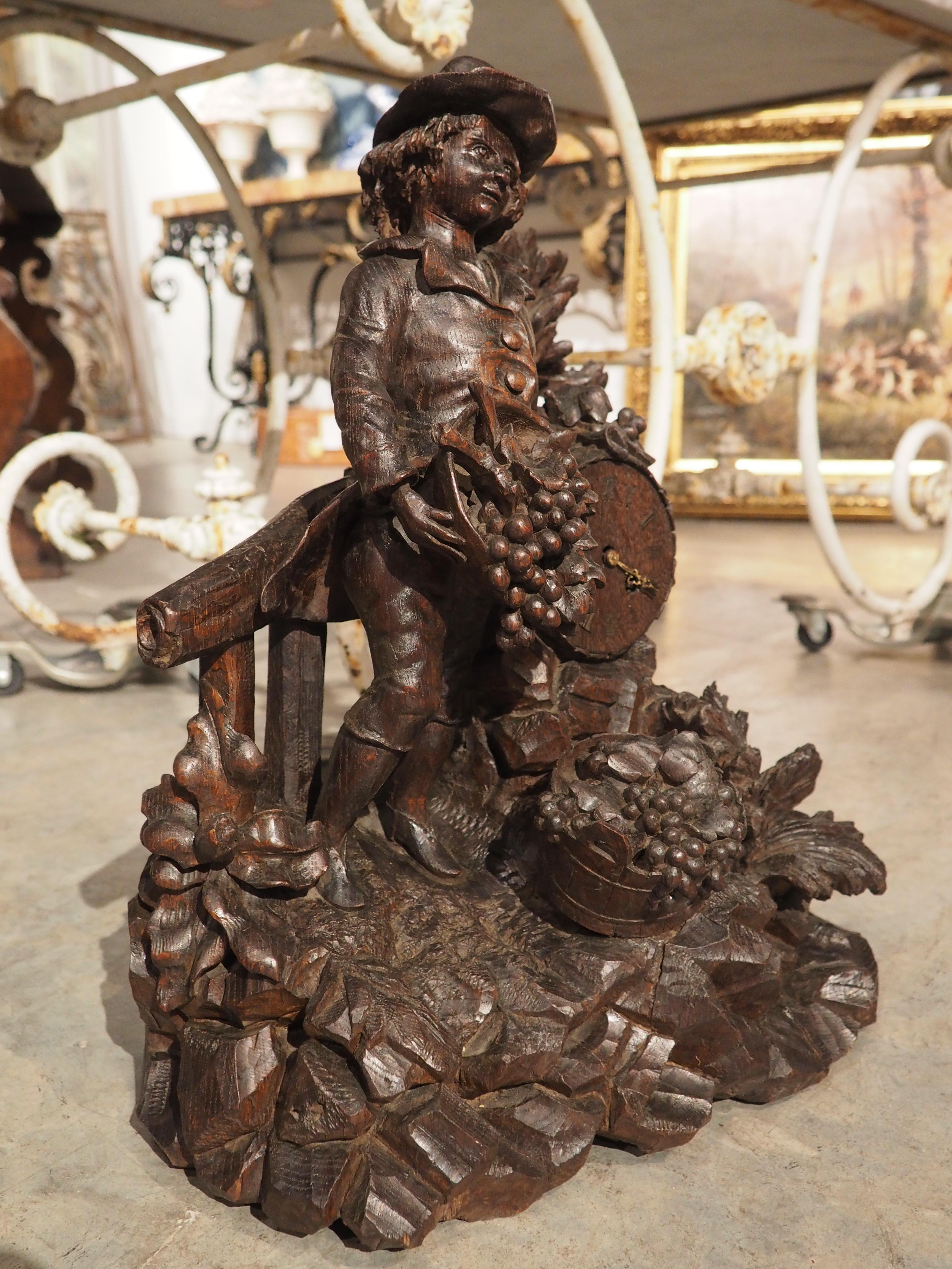 This beautiful sculpture has been carved from solid French oak during the latter half of the 19th century. The style is that of Black Forest, with realistic depictions of branches, leaves, grapes, and more. Originally a French clock, most of the