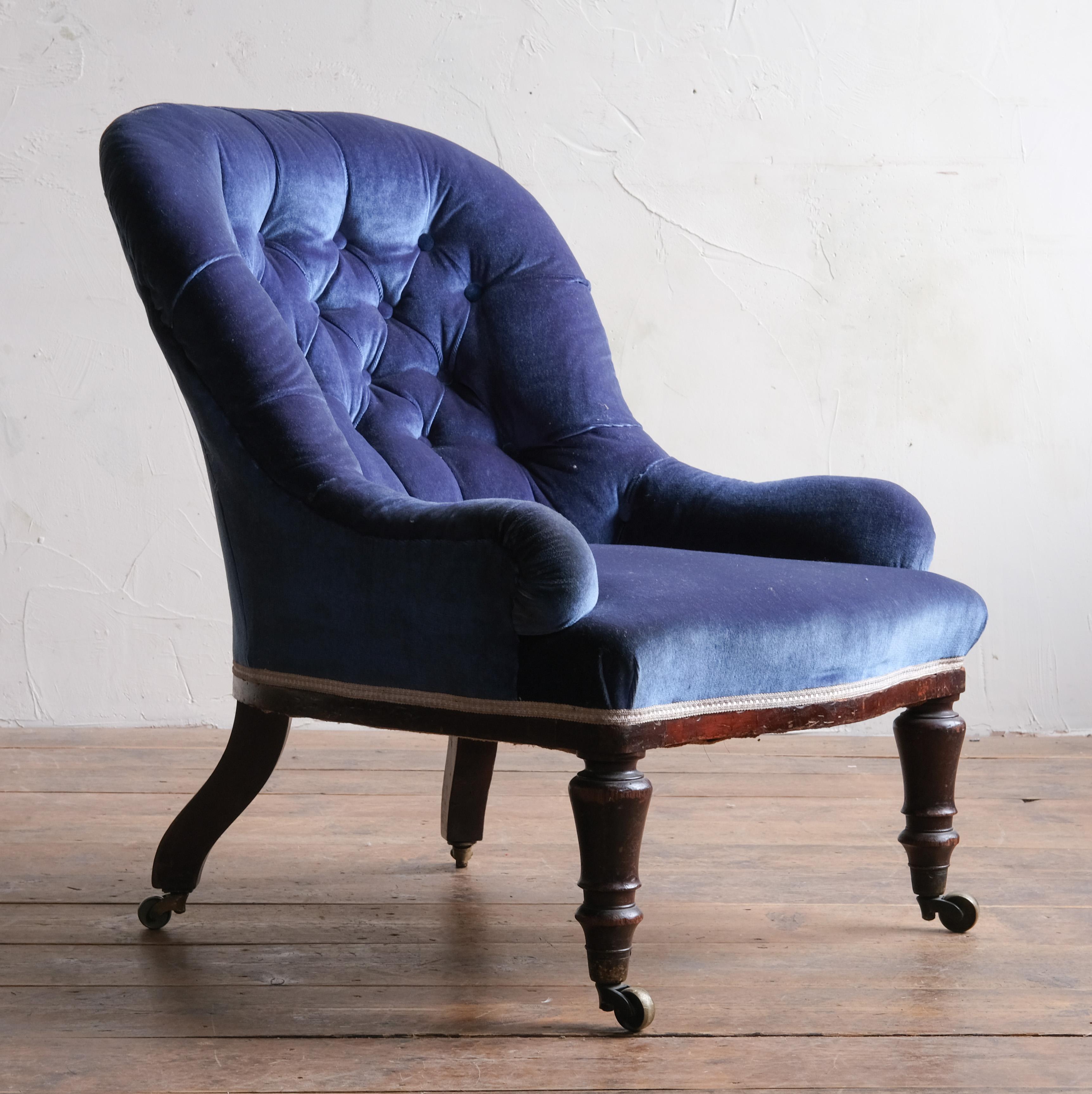 A good quality slipper chair by renowned English maker Holland & Sons. Raised on turned mahogany front legs and original Cope & Collinson brass casters. The rear legs out splayed with one showing the Holland stamp. The other leg with a historical