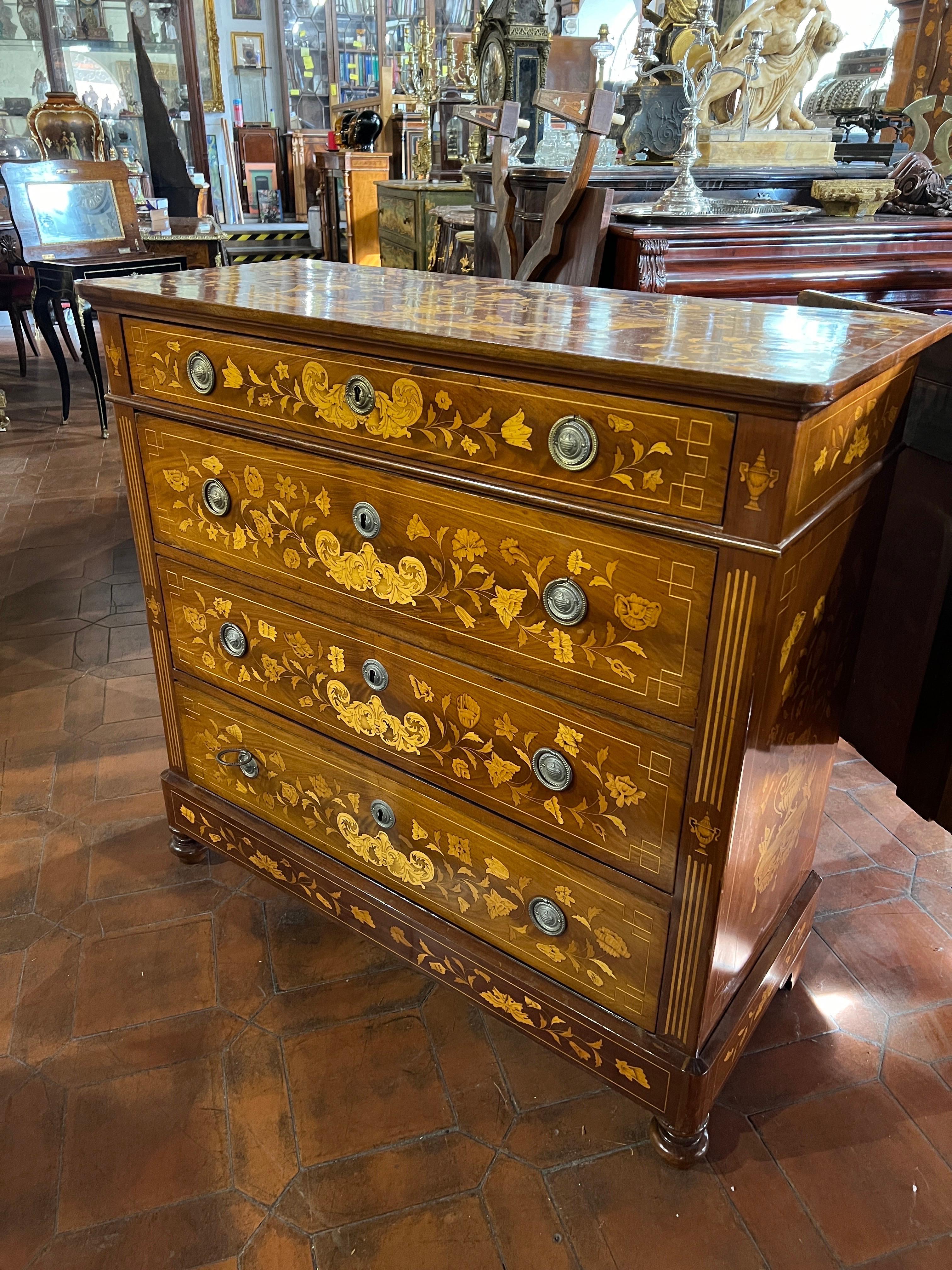 Fantastic Dutch Chest of Drawers , Charles X era , circa 1820, mahogany wood, beautiful wood grain, inlaid with floral motifs, amphorae and butterflies in fruit wood, four drawers and a perfect size for those looking for a shallow yet beautiful and