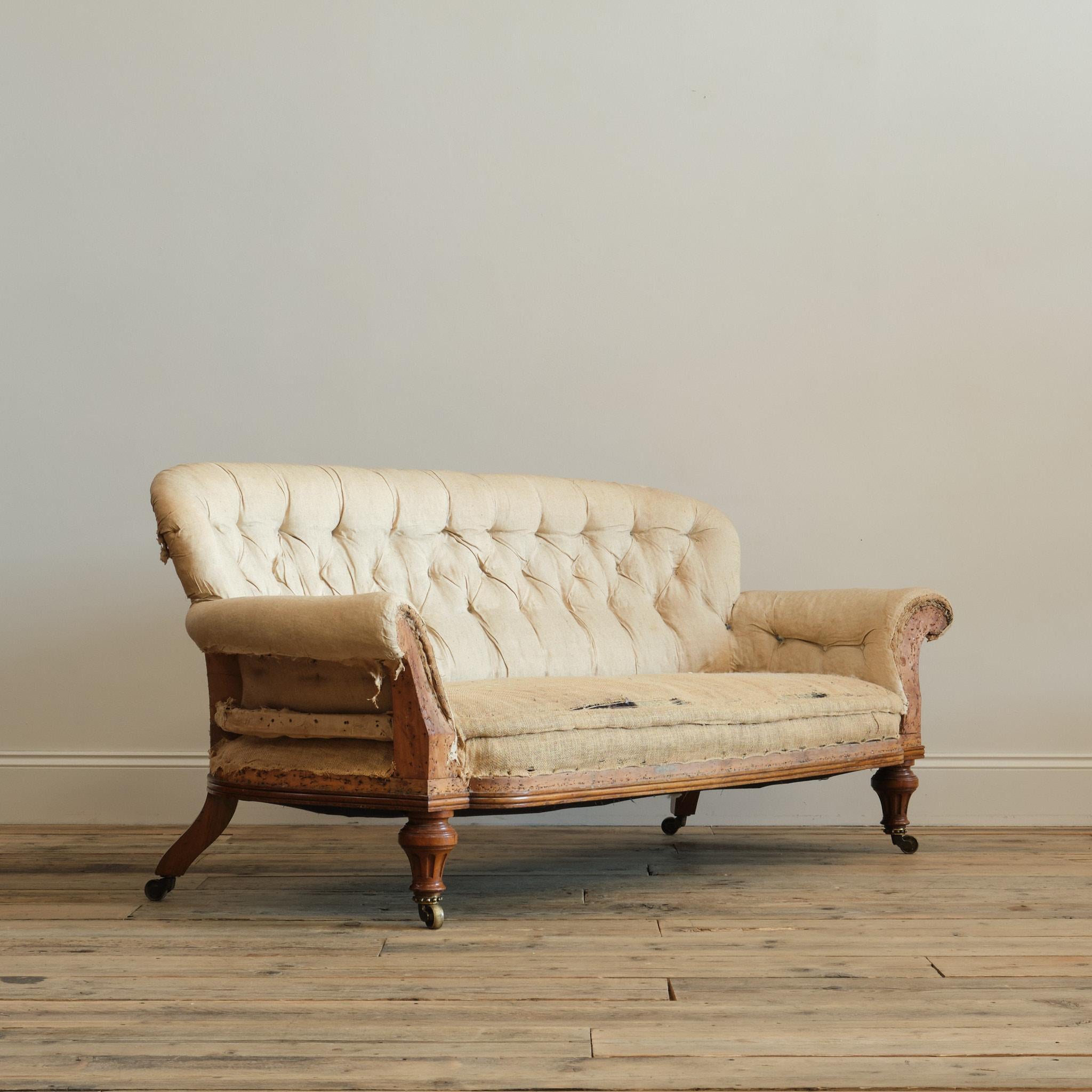 A superb mid 19th century sofa by Holland and Sons - London c1850. The Shapely walnut frame raised on thick and turned reeded walnut front with outward splayed rear legs. Both back legs stamped with the makers mark and one leg with the journeyman's