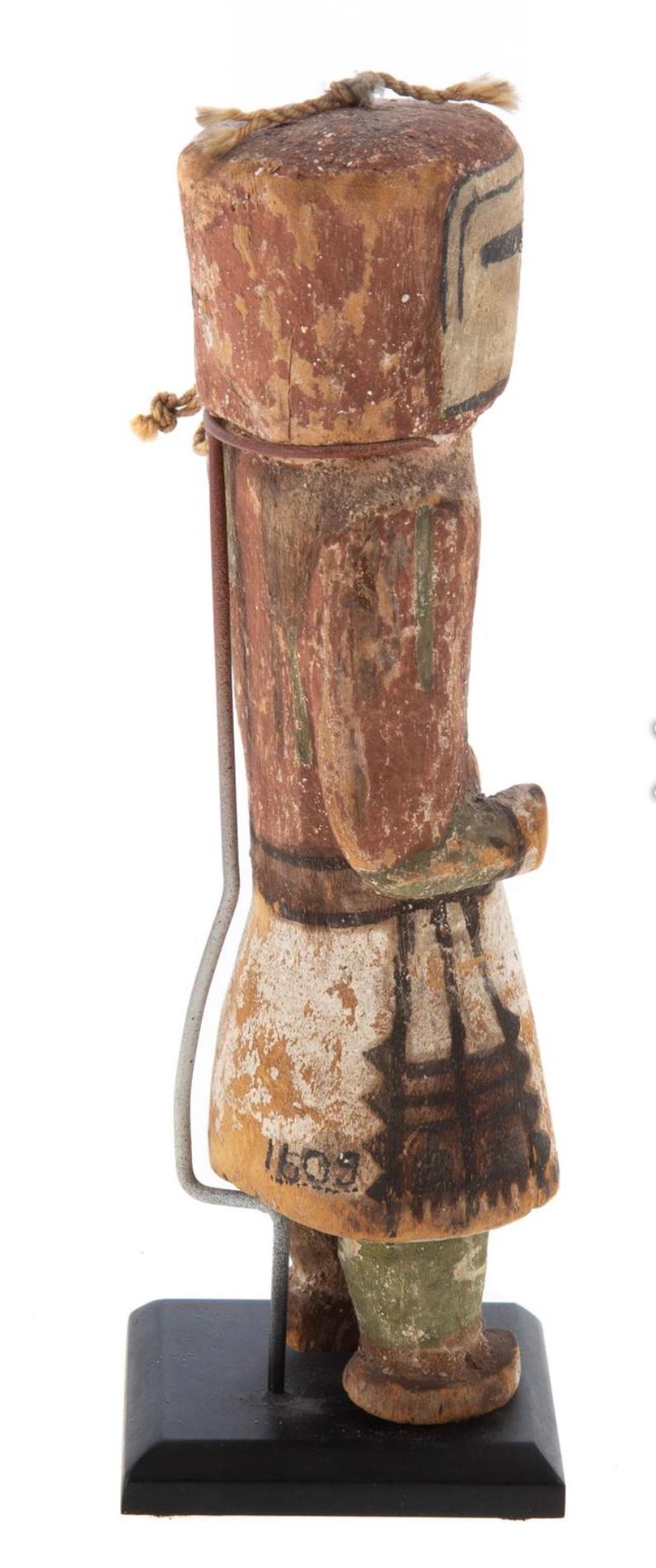 19th Century Hopi carved Kachina doll.
Circa 1900: cottonwood with earthen pigments, 7 3/8 in. H., with a stand. Collection inventory number on back of skirt.