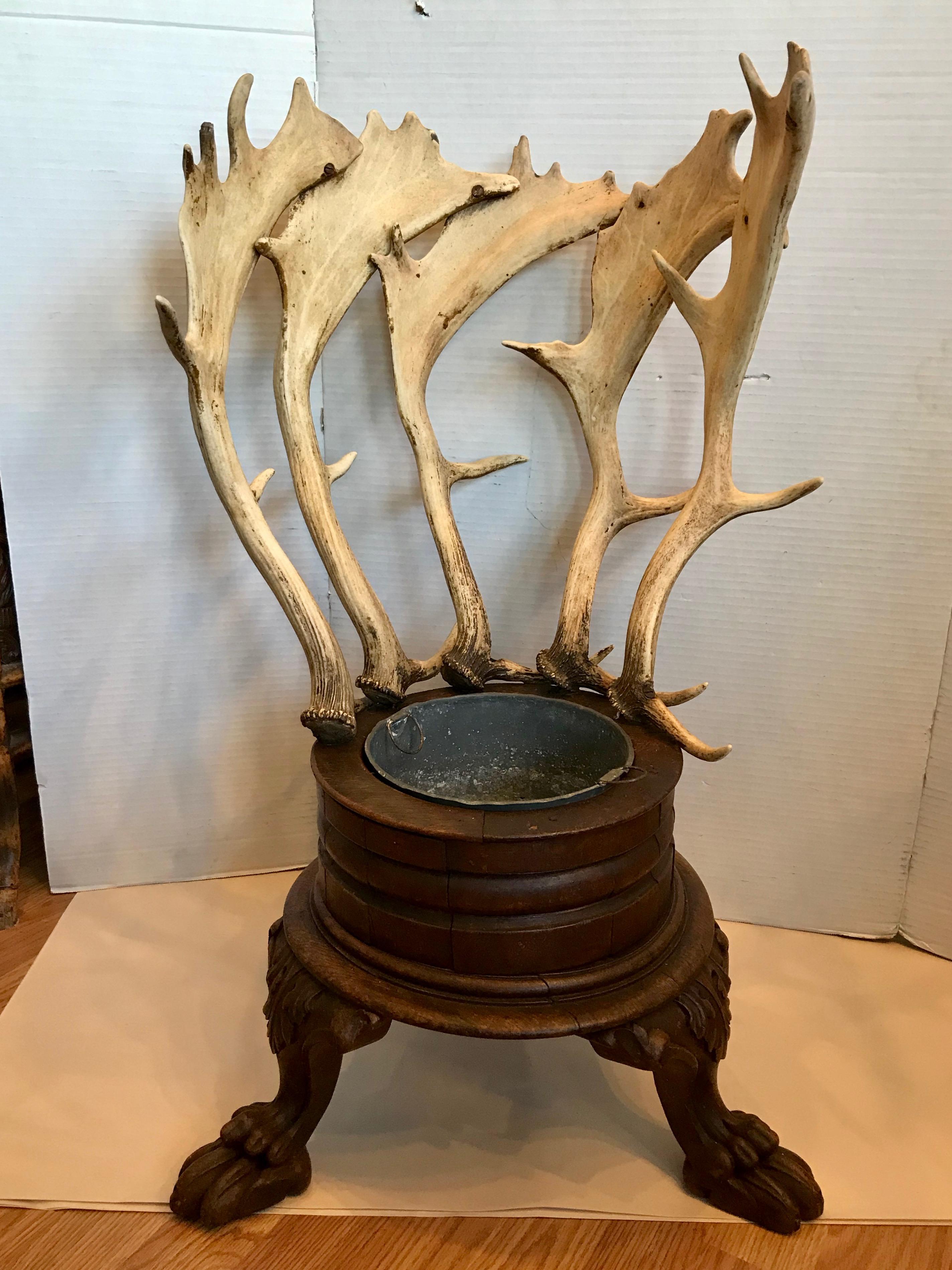 Dramatic in scale and proportion. A rare and substantial piece of unusual
design. The piece is raised upon curved, carved legs that terminate with claw feet. The removable liner is original. A singularly stunning continental
piece