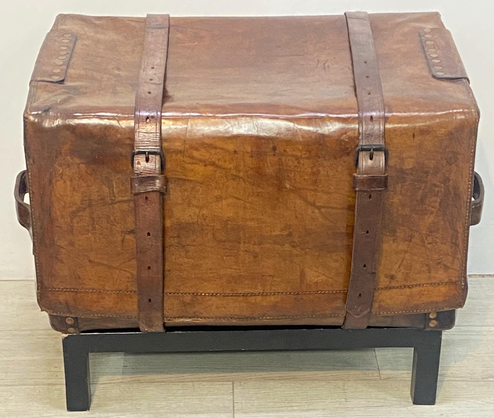 An impressive and possibly unique custom made leather carriage trunk. 
This could also be used as an end table with a glass top, or a seat if reinforced on the inside. Having original horse hide straps and blue and white cotton ticking interior
