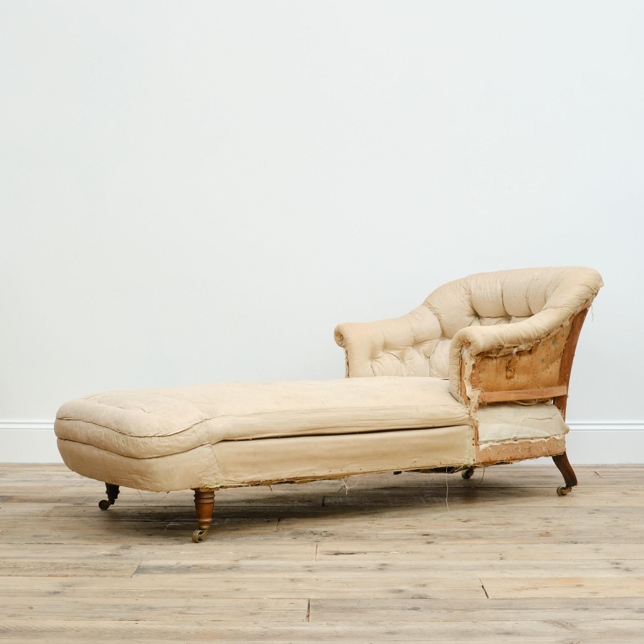 A wonderful late 19th century country house daybed, very much in the manner of a Howard & Sons tub chair. Raised on turned mahogany legs and the original brass casters. With an extra long seat depth and generously wide. It also retains the original