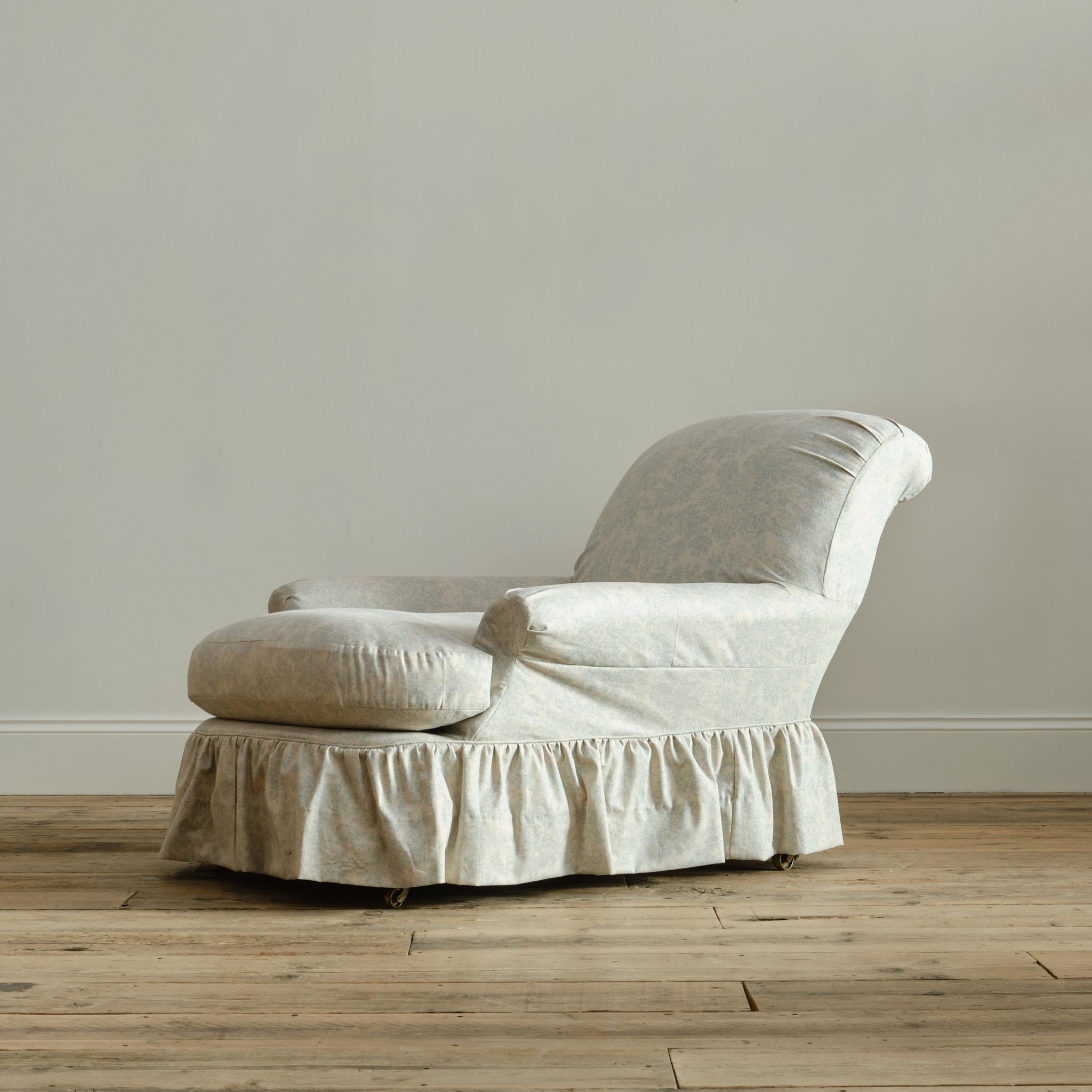 A deep seated country house 'club' armchair by the renowned Howard & Sons - London. The walnut frame on turned and partially ebonized front legs with Cope & Collinson brass casters.  

c1860

Expertly upholstered using traditional methods and