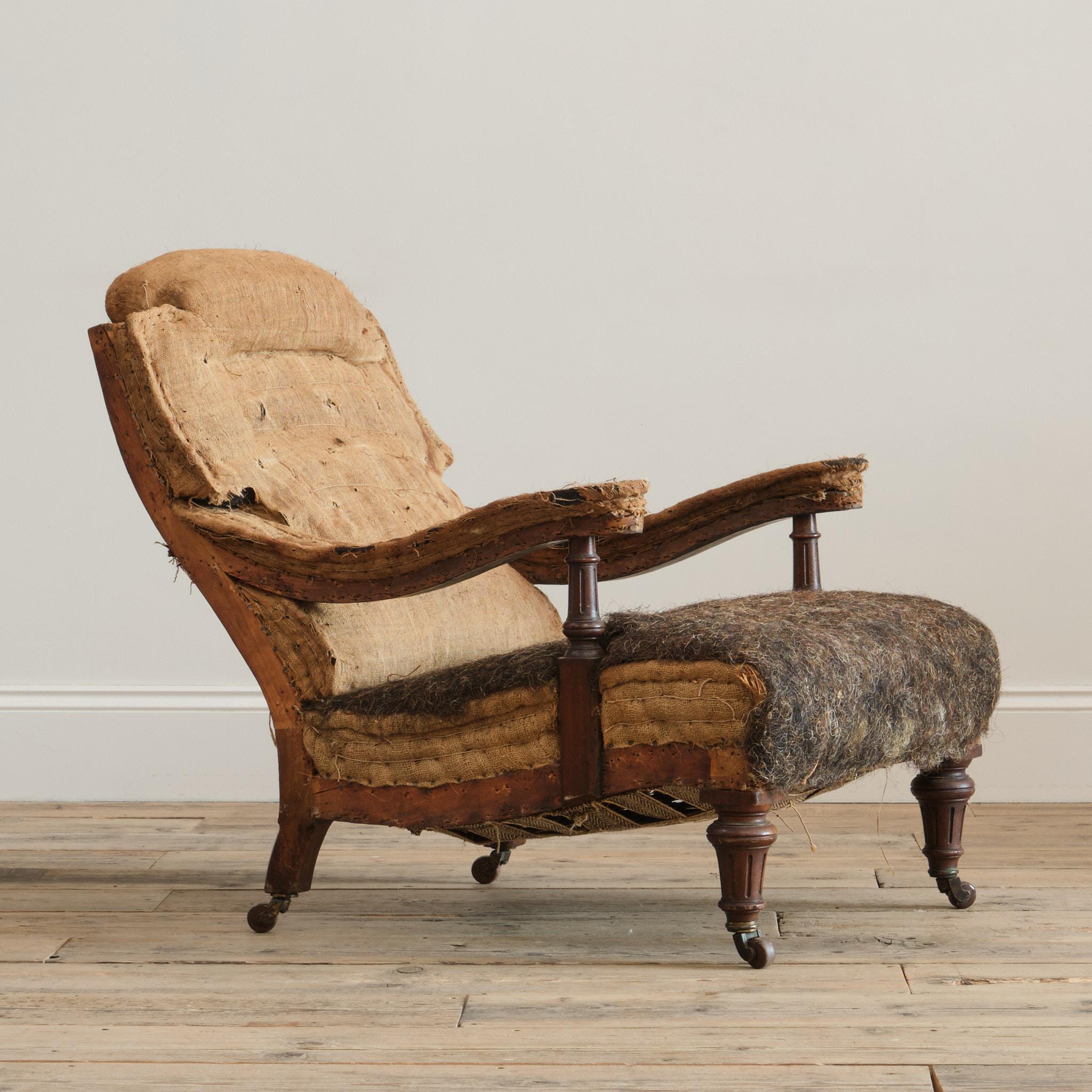 A good quality 19th century open armchair in the manner of Howard & Sons. Raised on turned legs and arm supports and retaining the original casters. English c1870

Retaining its original horse hair fillings. 

Structurally in good solid order and