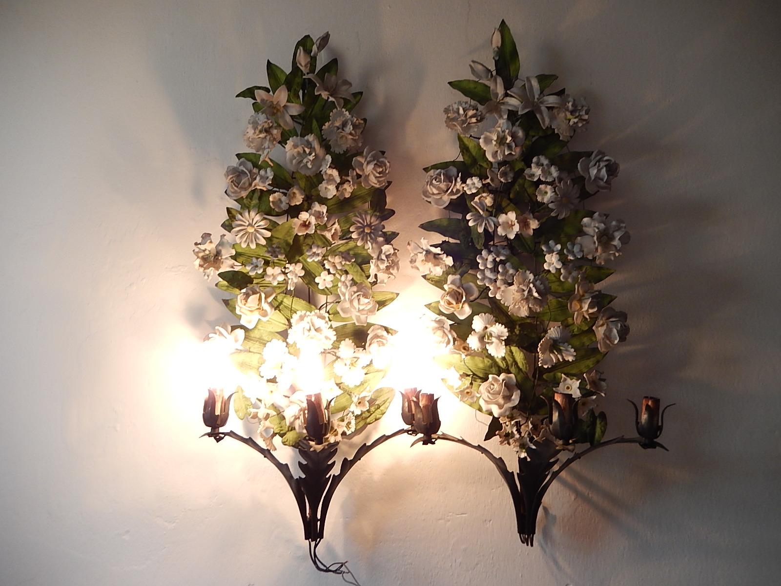 Extremely rare sconces. Housing 3 lights each. Original color on tole leaves. Adorning huge handmade flowers in bisque porcelain. Some may have petals missing and flea bites. Re wired and ready to hang. Free priority shipping from Italy.