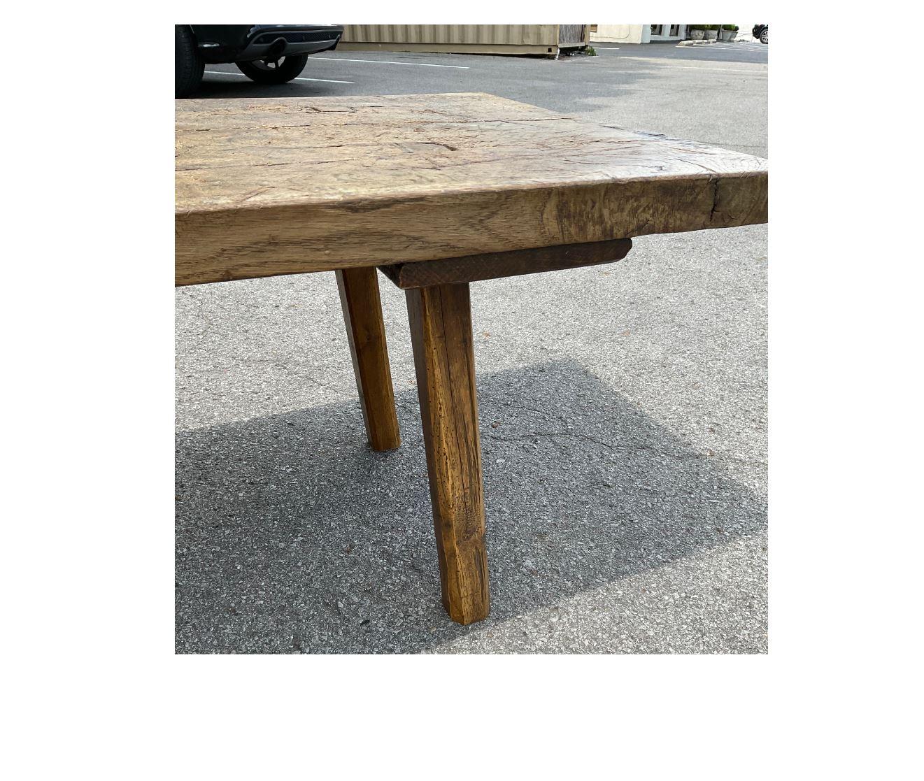This piece was originally a Hungarian chopping table and has now been cut down to coffee table height. The top is 2 inches thick and very heavy and durable. The character and patina of this piece are amazing! This unique table would make an