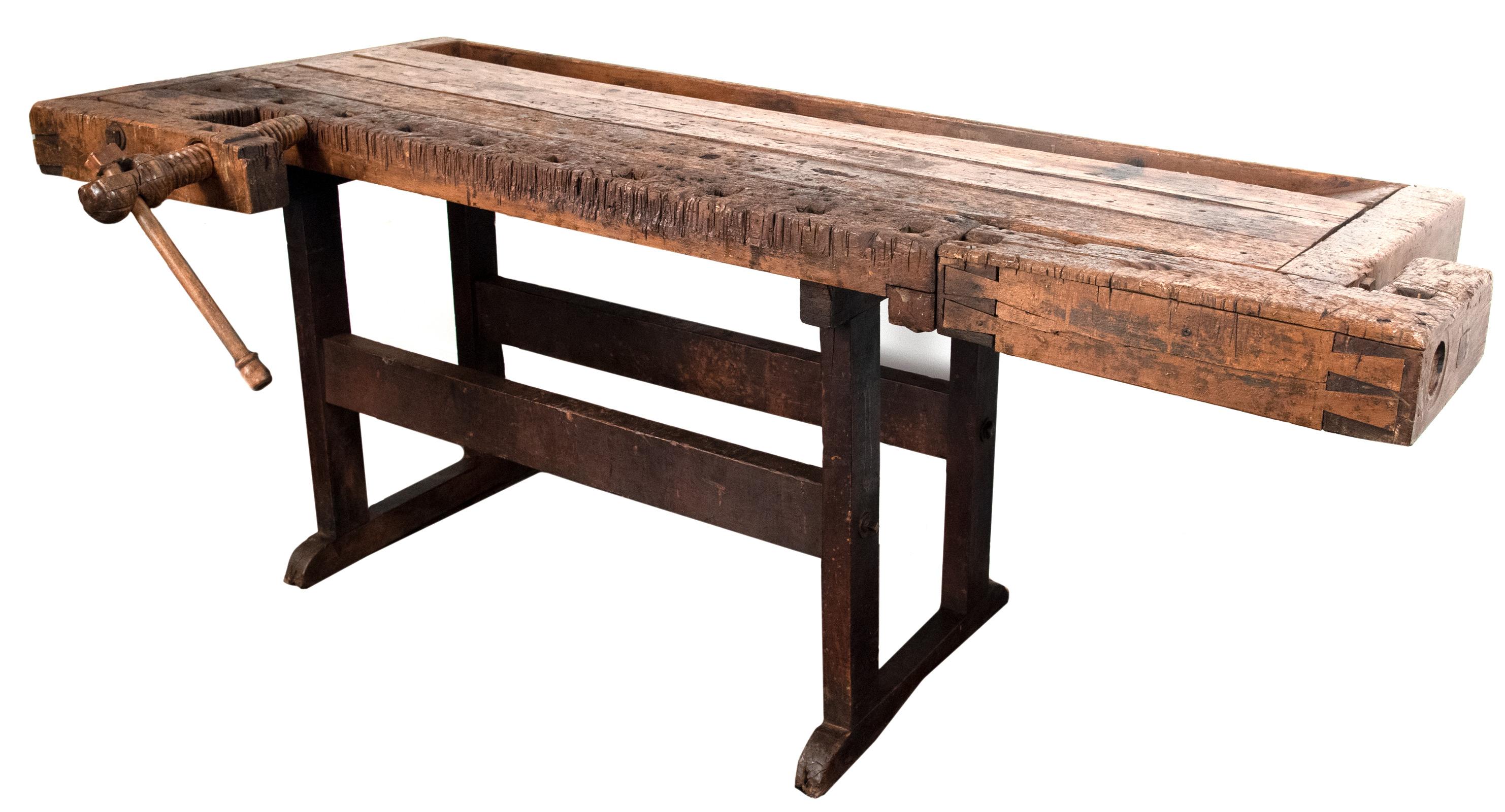 The form of this 150-year-old walnut bench is much older; and can be found in descriptions dating to the early middle ages. The product of successive generations of improved forms, the table is a kind of all-purpose surface, with clamps, holders,