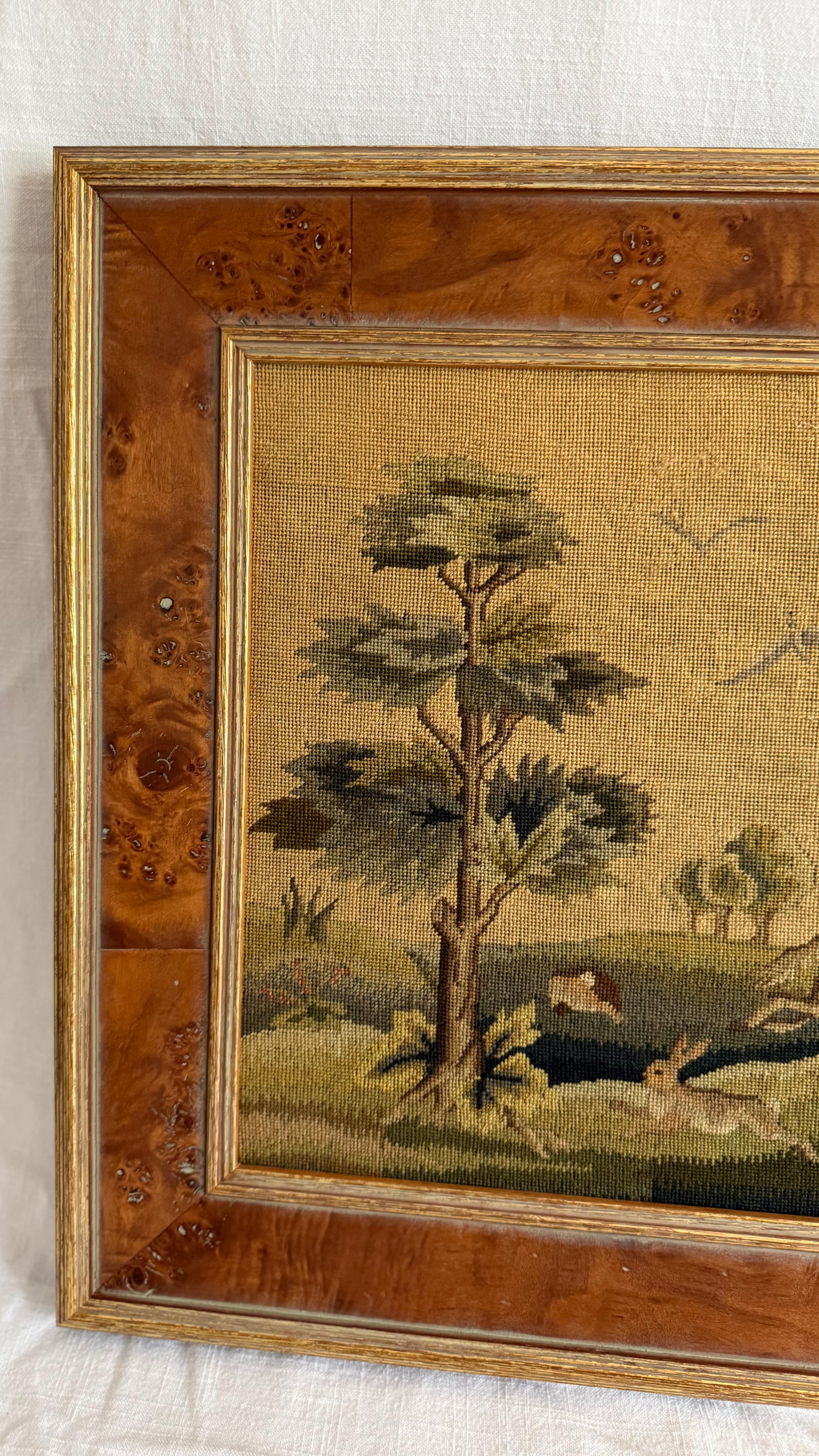 This exquisite 19th century needlepoint tapestry captures a lively and detailed pastoral hunting scene, rendered with remarkable craftsmanship and rich, earthy tones. A striking example of Victorian needlework, the composition features a gallant