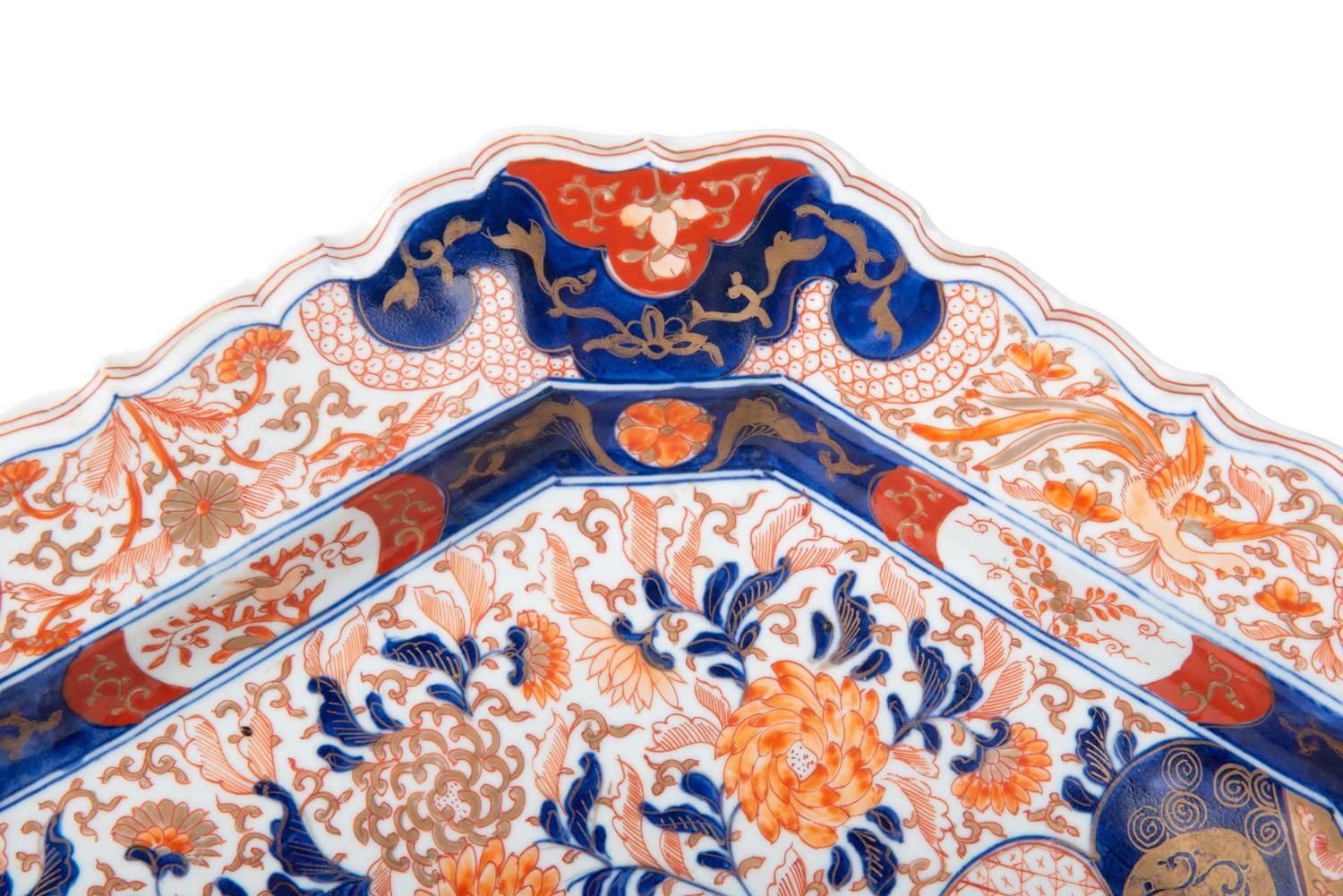 A good quality 19th century Japanese Imari charge, hexagonal in shape, having the classical blue and orange colors. Depicting flower and motif decoration to the whole.